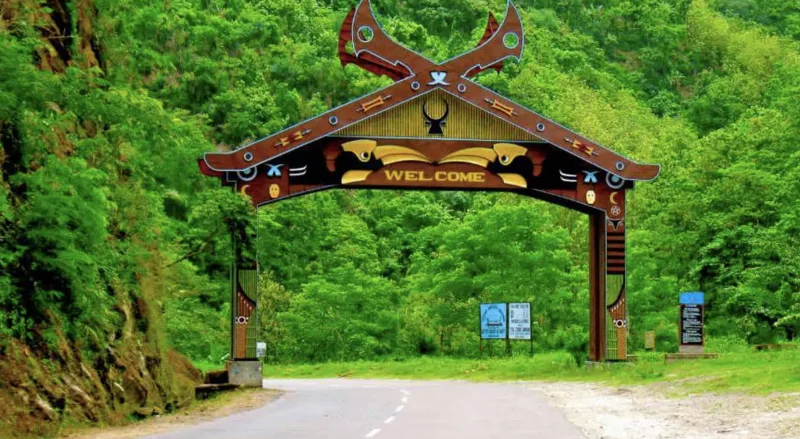 Traditional Naga-style welcome arch at the entrance to Nagaland, surrounded by dense green forest