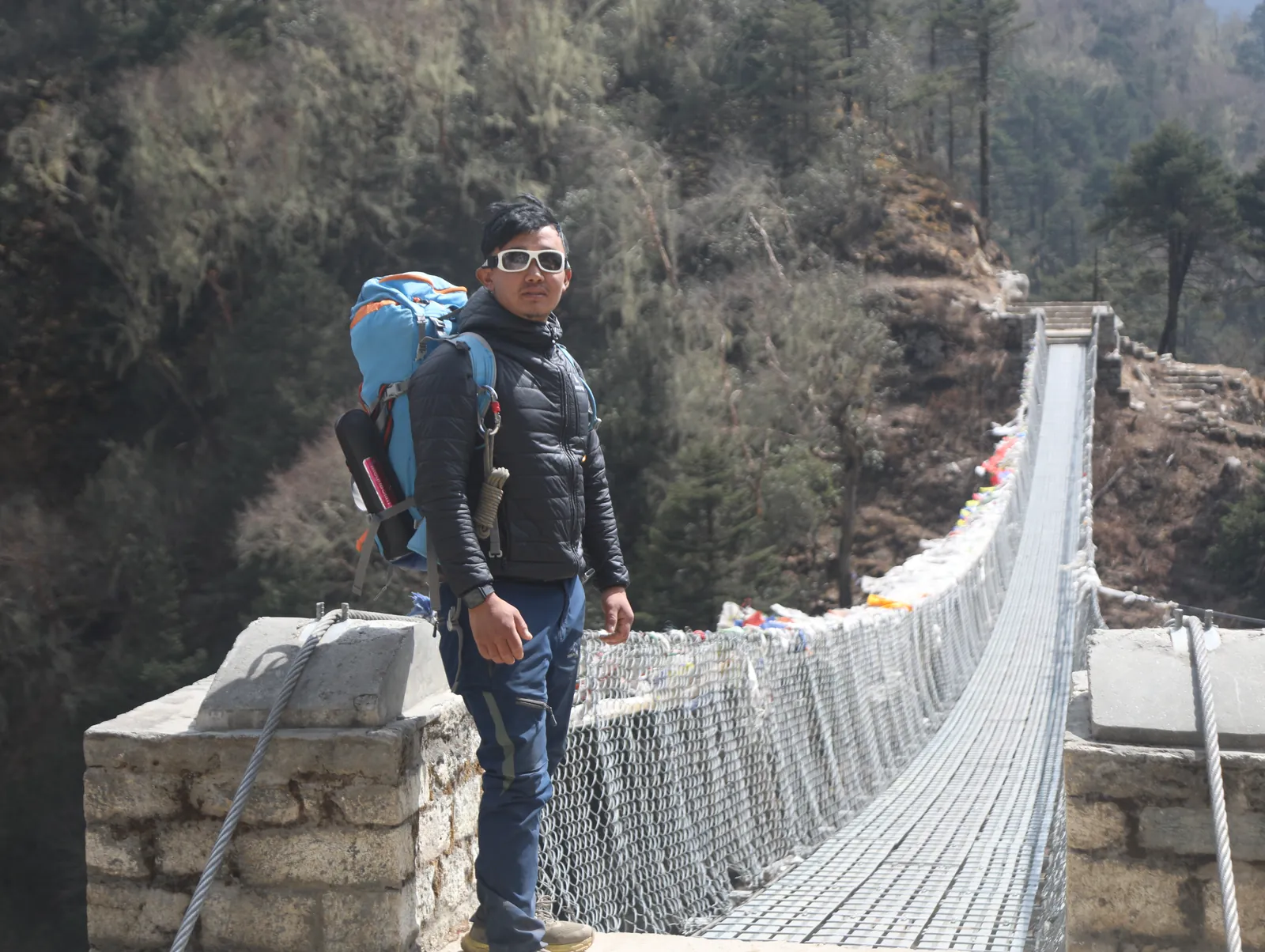 Posing bridge on the Everest Base Camp group trip with One in the Orange Jacket.