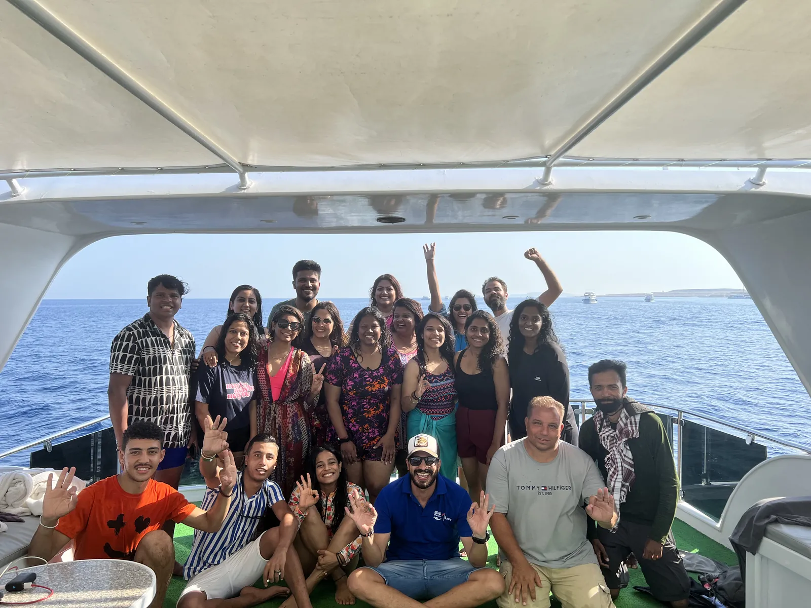 Water boat everyone smiling on the Egypt & Jordan group trip with One in the Orange Jacket.