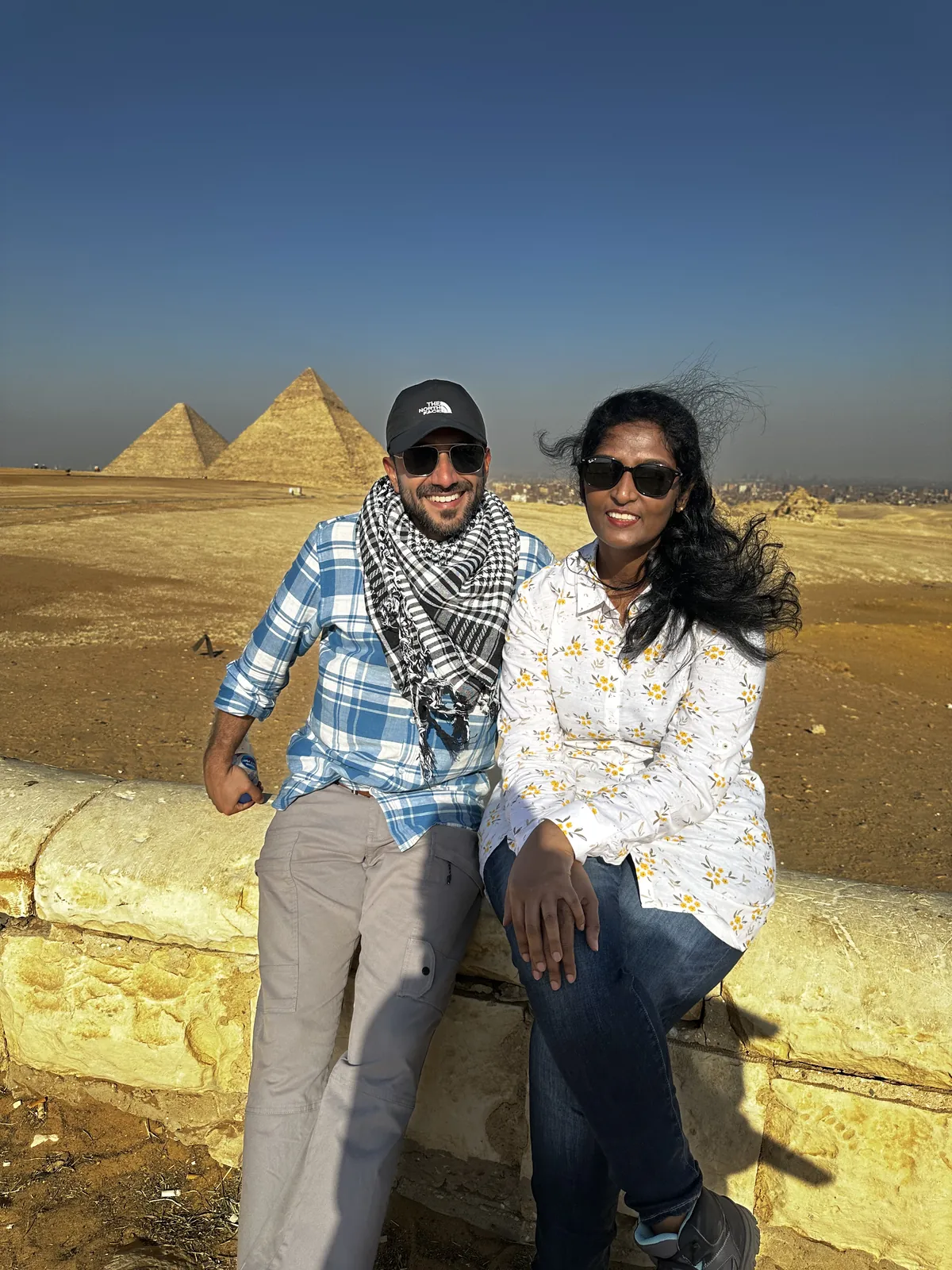 Couple smiling pyramids on the Egypt & Jordan group trip with One in the Orange Jacket.
