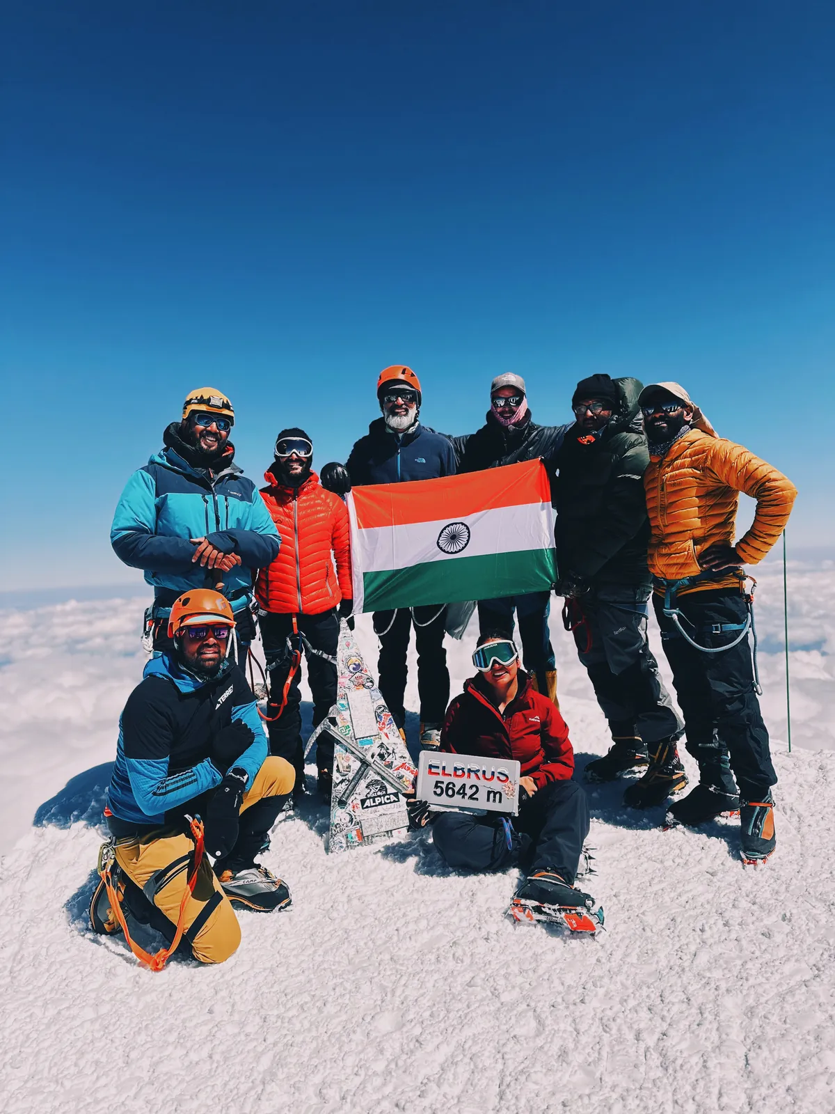 Mountain celebrating summit success on the Mount Elbrus group trip with One in the Orange Jacket.