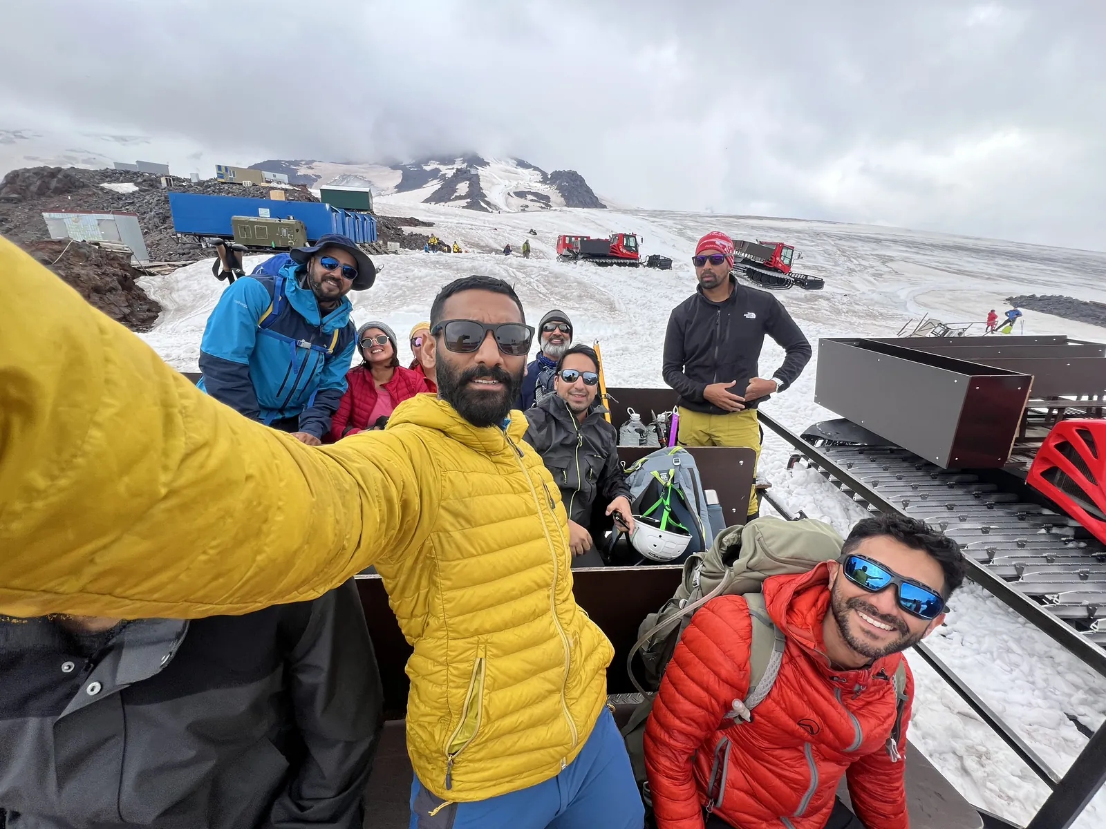 Mountain selfie snowy on the Mount Elbrus group trip with One in the Orange Jacket.