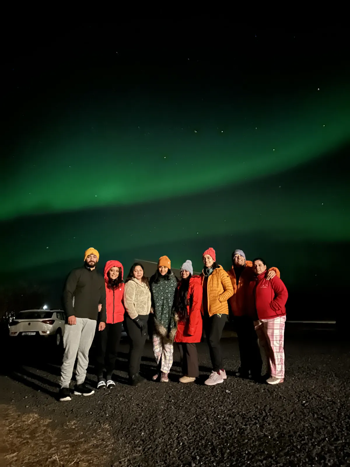 Night aurora borealis happy on the Iceland group trip with One in the Orange Jacket.