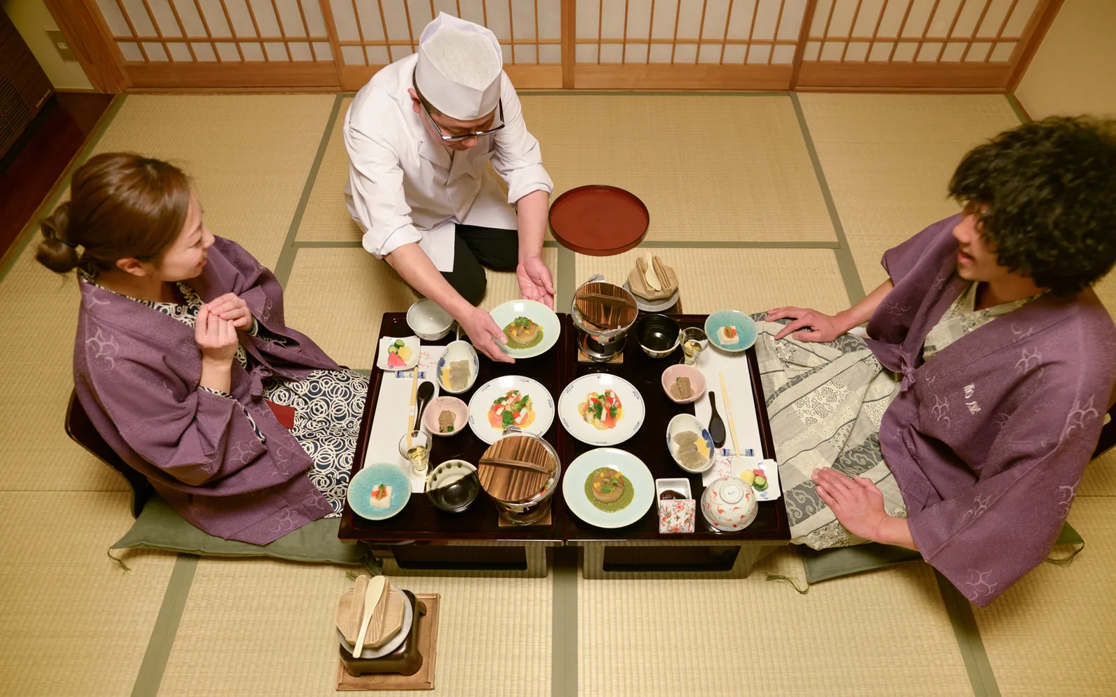 Chef serves traditional on the Japan group trip with One in the Orange Jacket.
