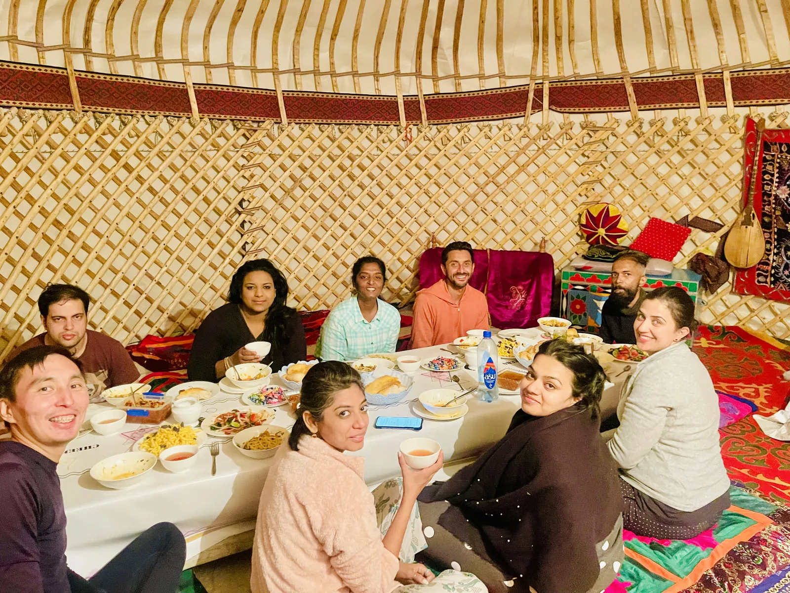 Travelers enjoying meal on the Kazakhstan group trip with One in the Orange Jacket.