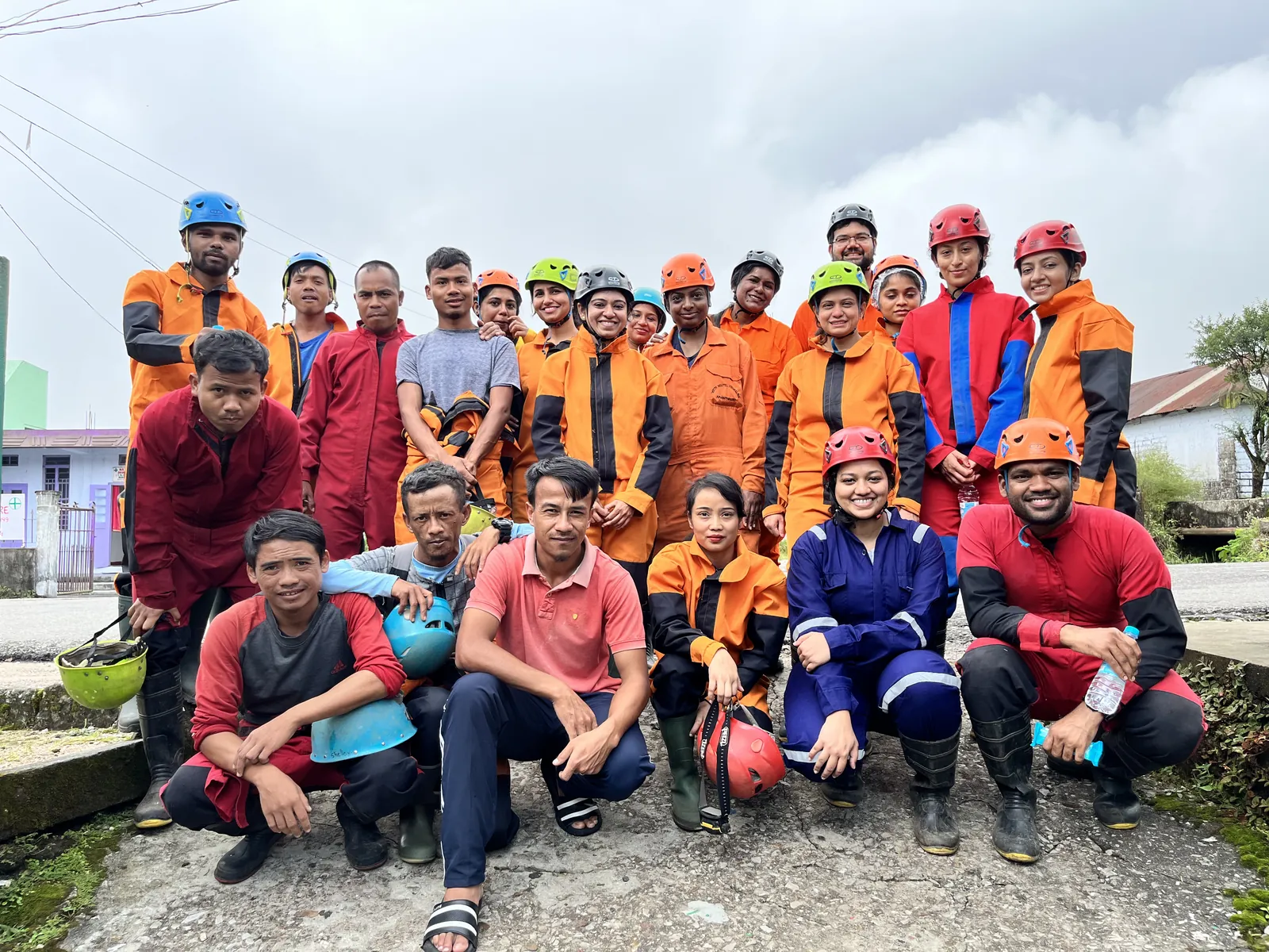 Smiling faces outfits on the Meghalaya group trip with One in the Orange Jacket.