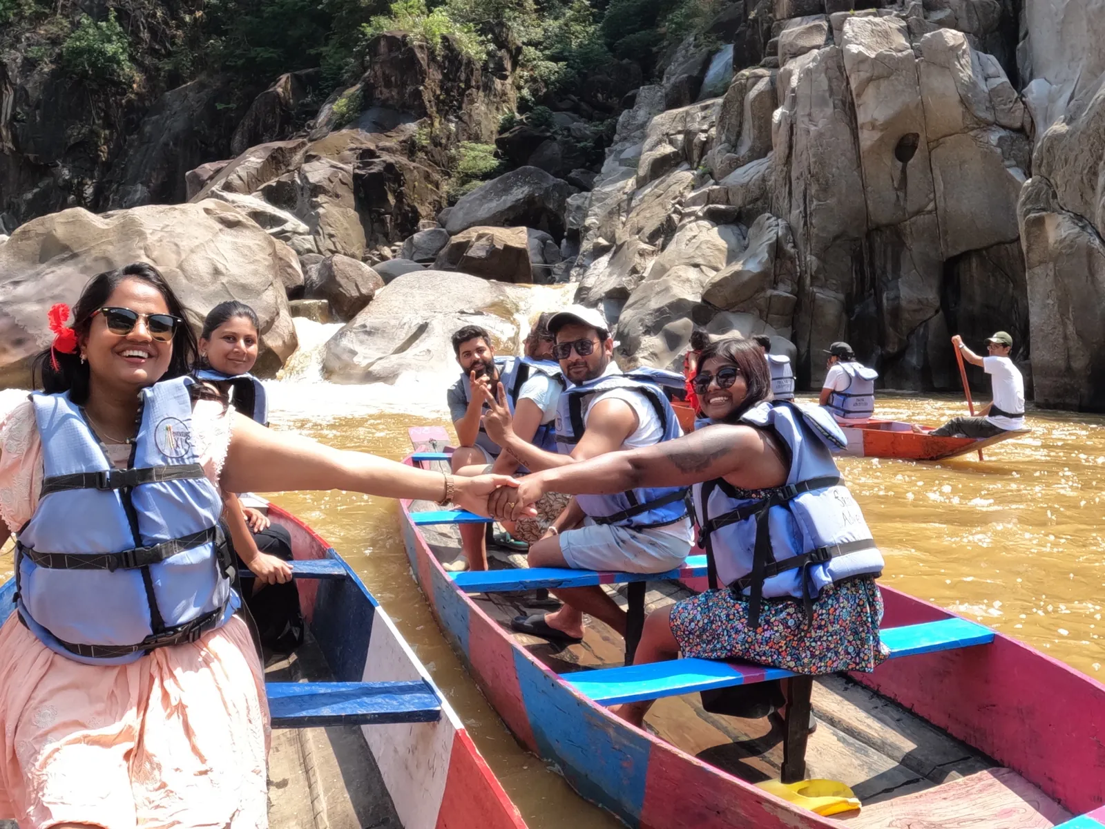 Water enjoying thrilling boat on the Meghalaya group trip with One in the Orange Jacket.