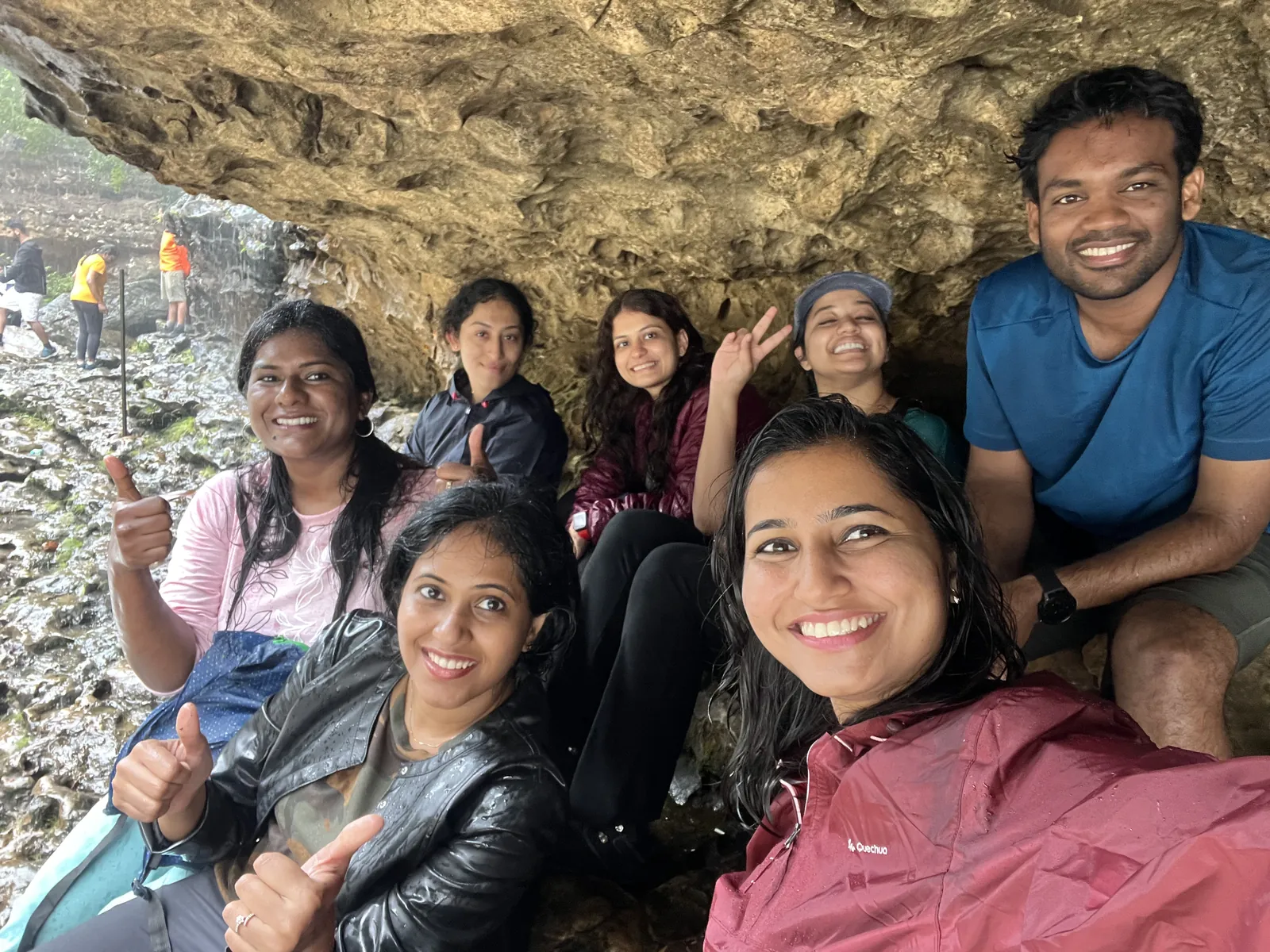 Smiles thumbs conveying on the Meghalaya group trip with One in the Orange Jacket.