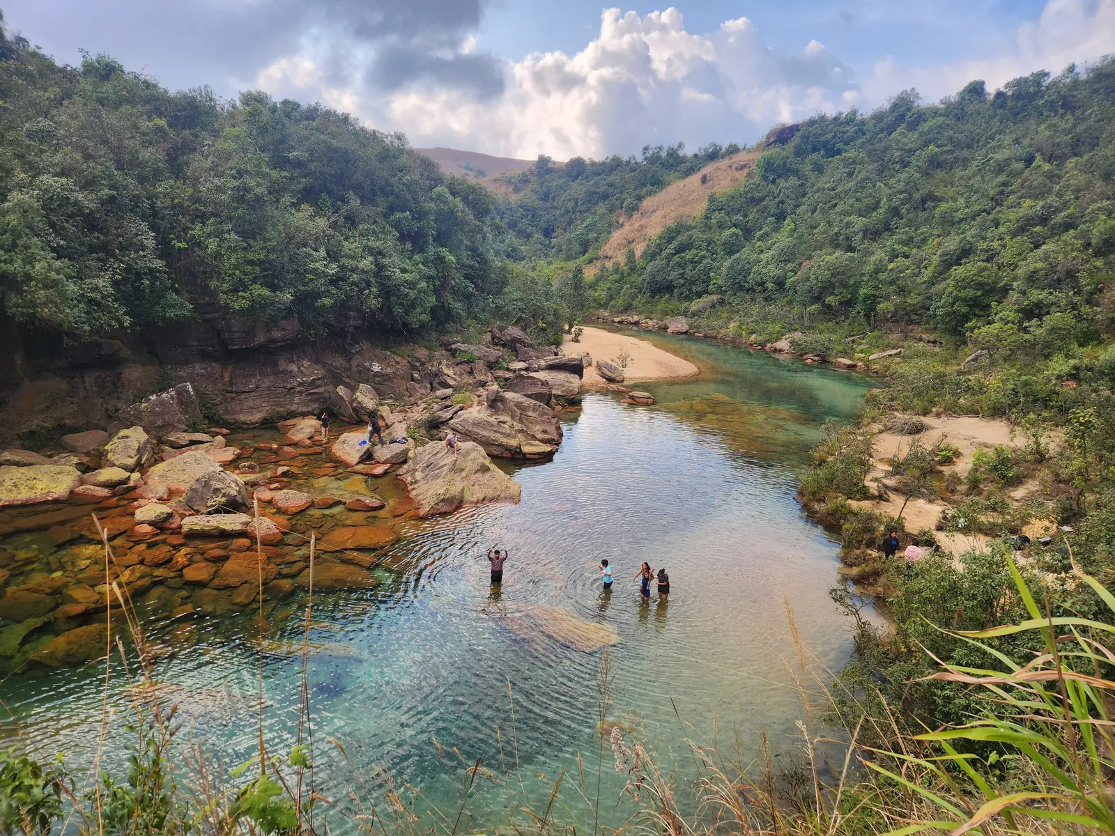 Water enjoying on the Meghalaya group trip with One in the Orange Jacket.