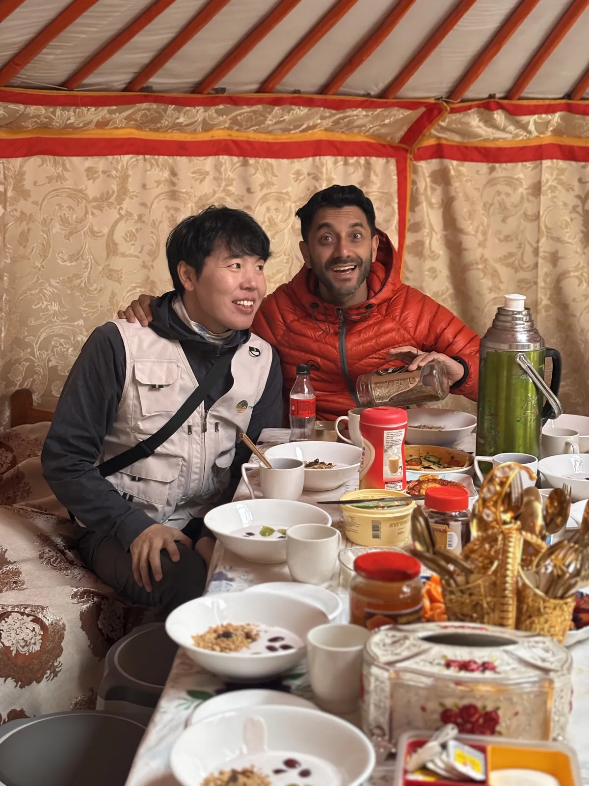 Men smiling inside on the Mongolia group trip with One in the Orange Jacket.