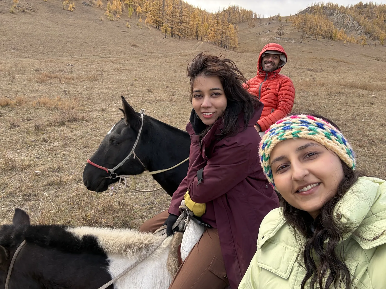 Three horses on the Mongolia group trip with One in the Orange Jacket.