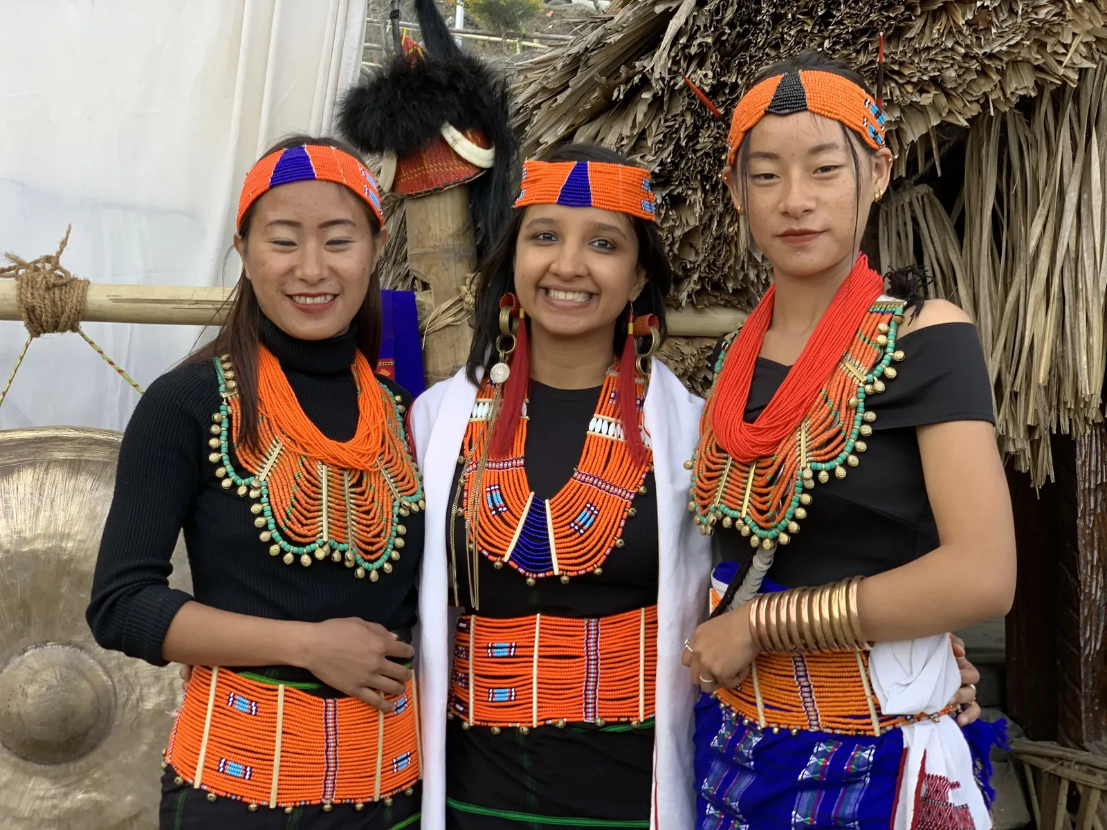 Authentic attire smiles on the Nagaland group trip with One in the Orange Jacket.
