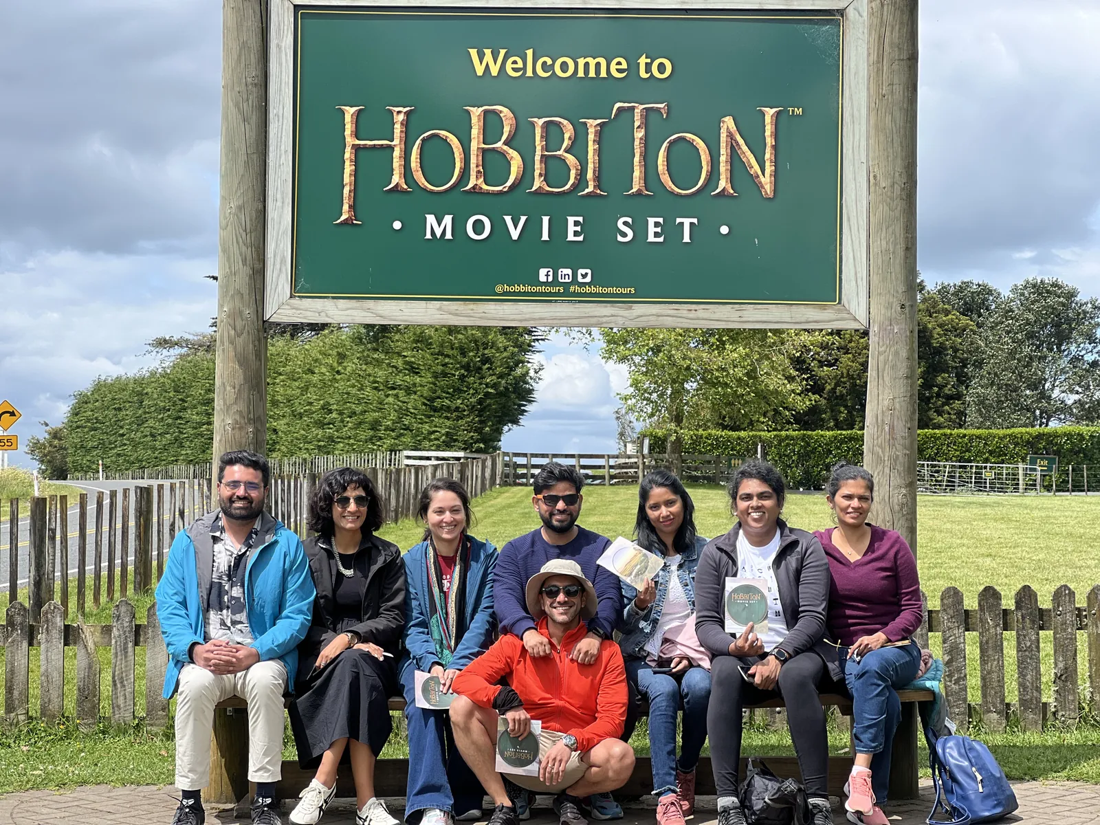 Hobbiton movie set on the New Zealand group trip with One in the Orange Jacket.