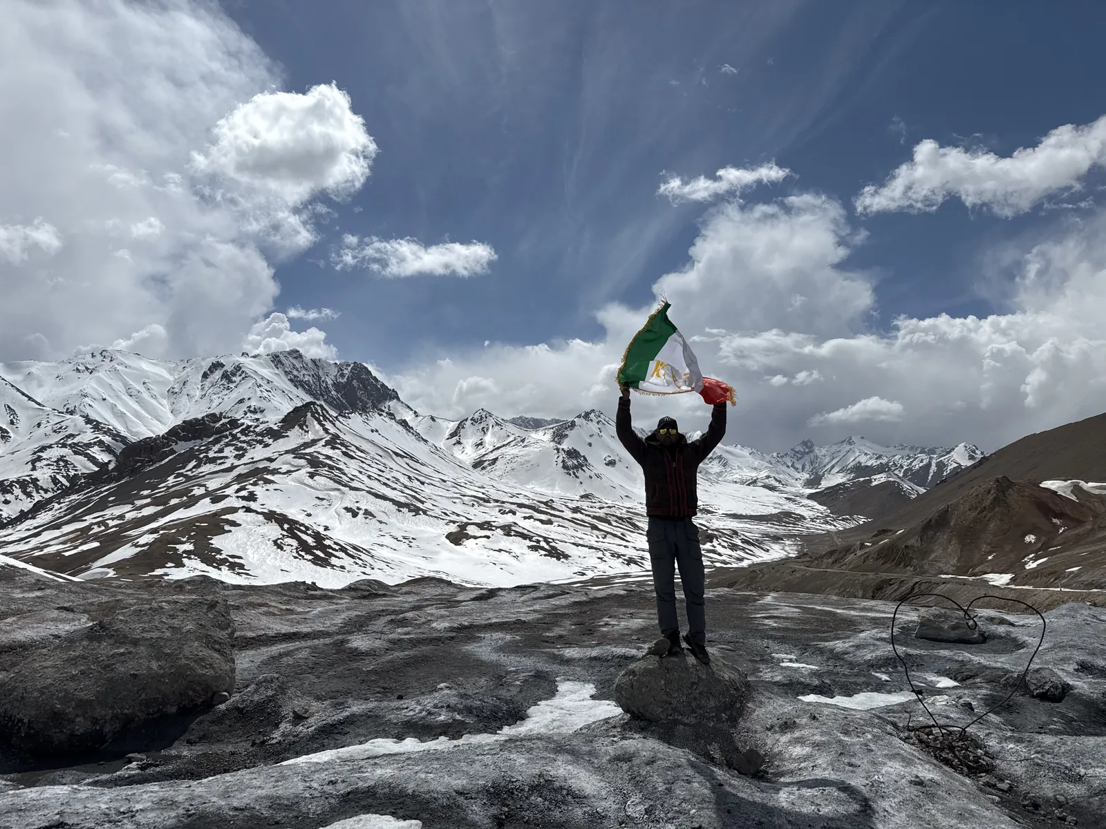 Mountain celebrating on the Pamir Highway group trip with One in the Orange Jacket.