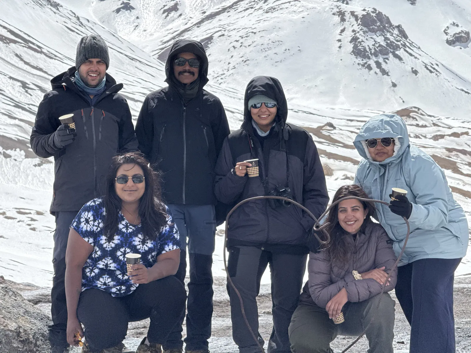 Mountain travelers snowy on the Pamir Highway group trip with One in the Orange Jacket.
