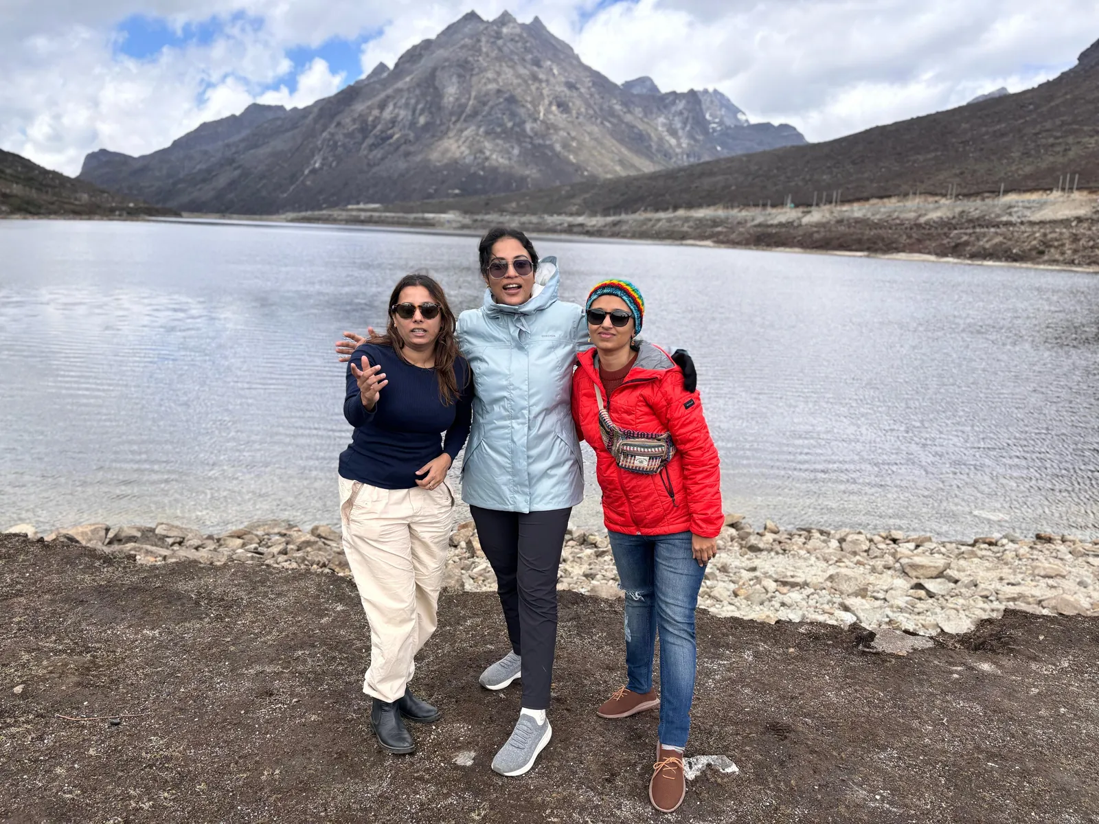 Water friends posing lake on the Tawang group trip with One in the Orange Jacket.