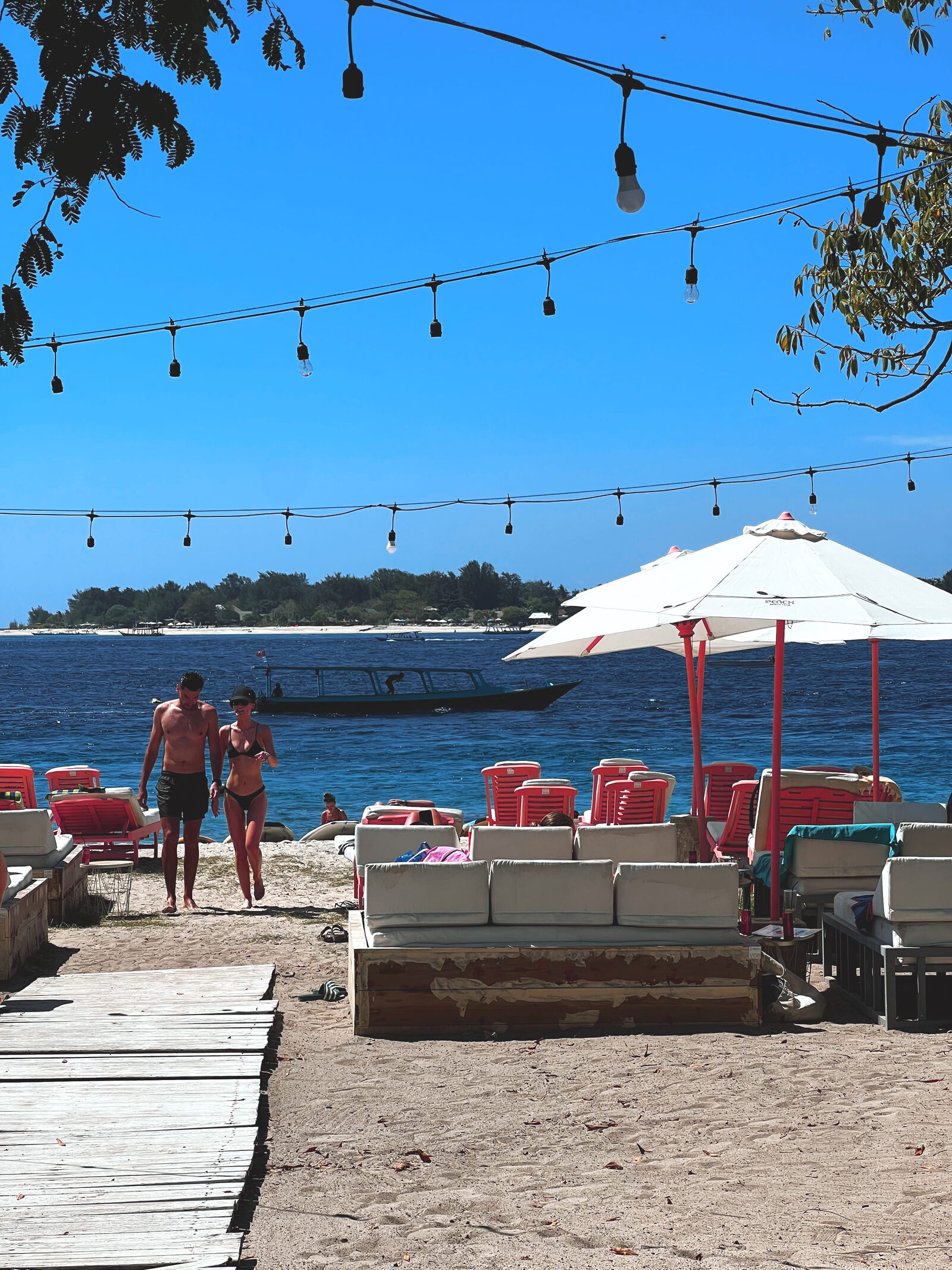 Gili Trawangan beach club with loungers and string lights