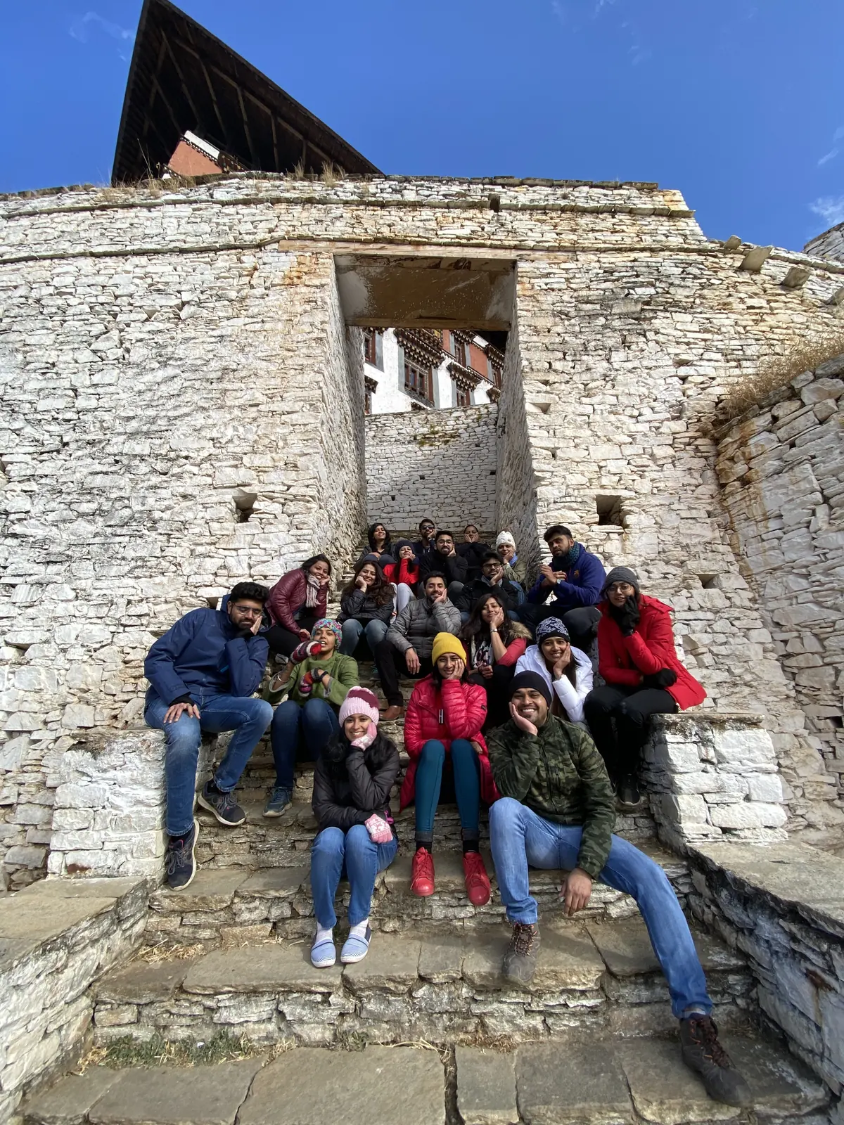 OJ group sitting on the stone steps of Paro Dzong