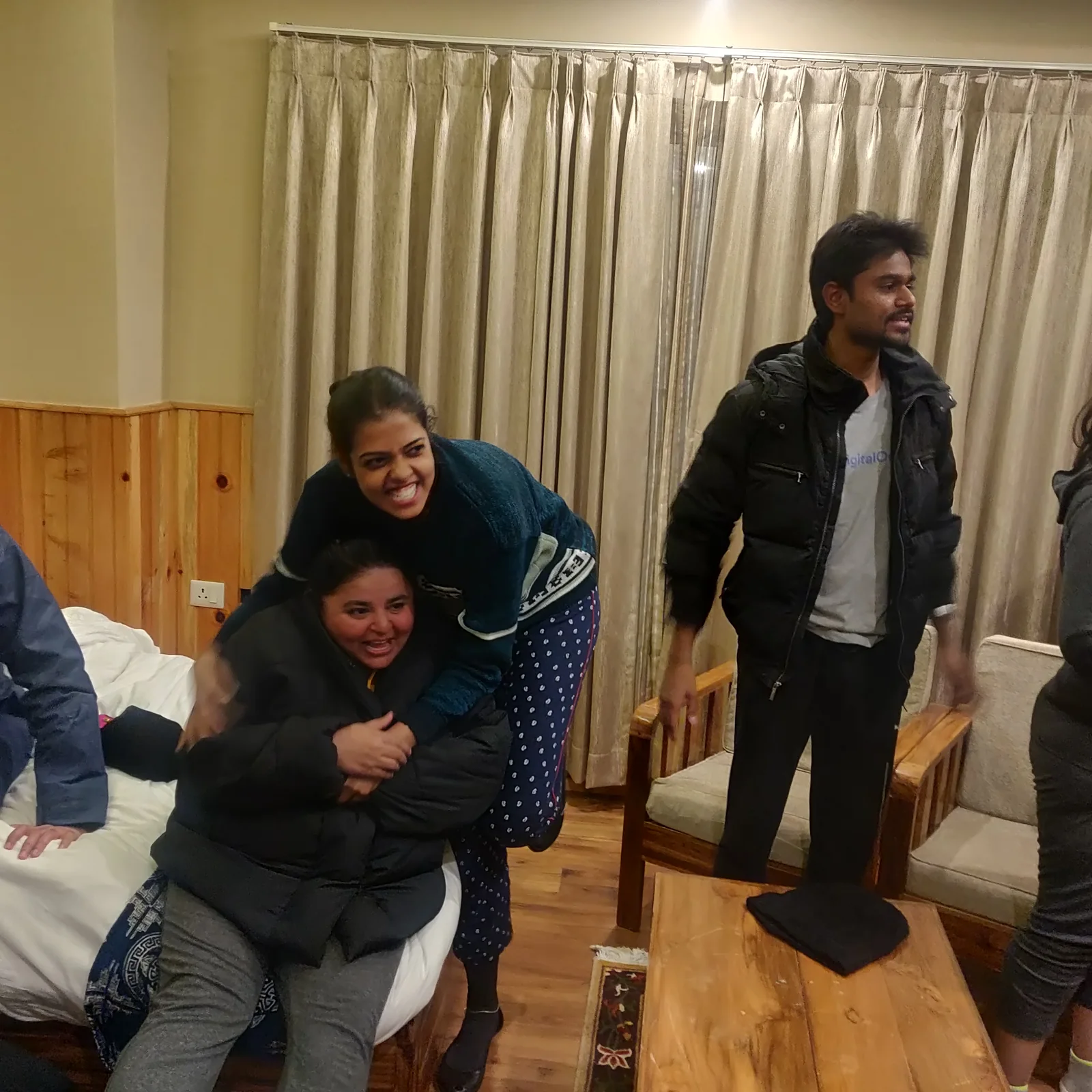 Trippers hugging goodbye in a Bhutan hotel room