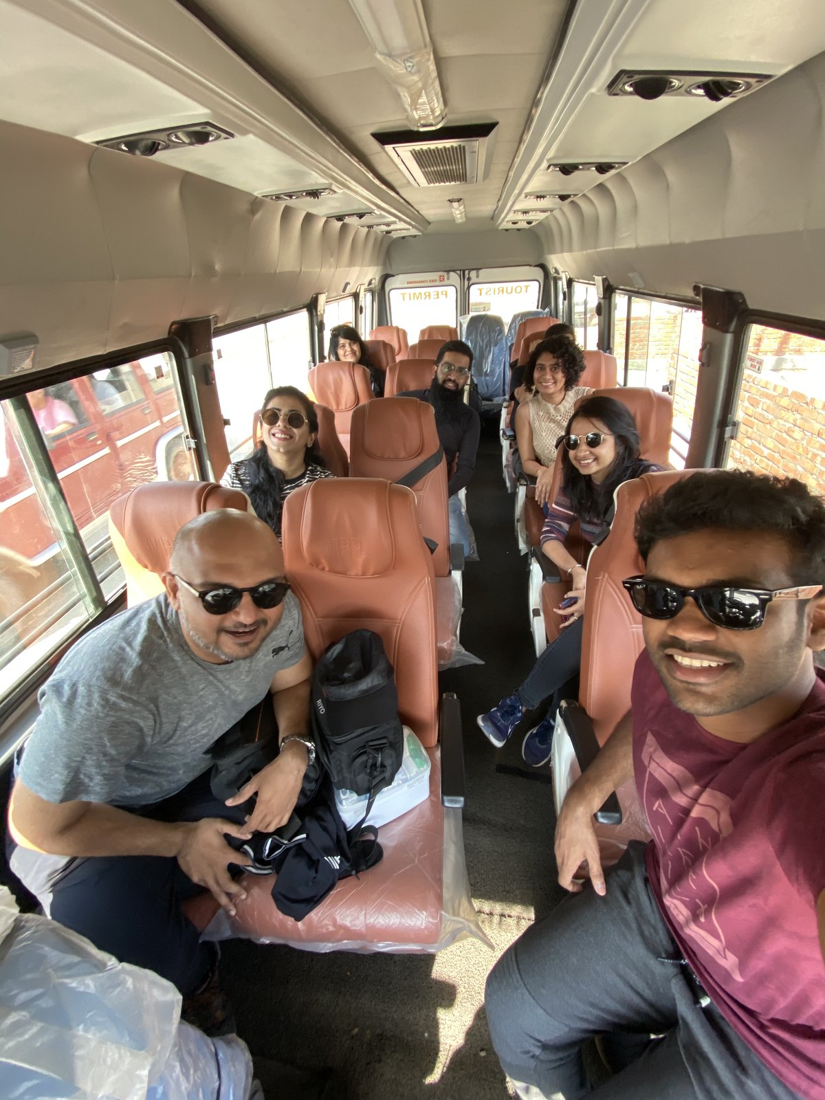 OJ trippers smiling in the group bus on the way from Dimapur to Kohima