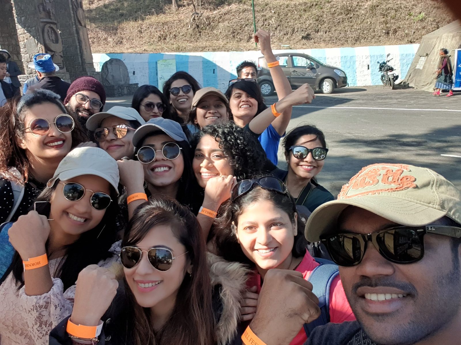 OJ group selfie at the Hornbill Festival, orange festival wristbands up