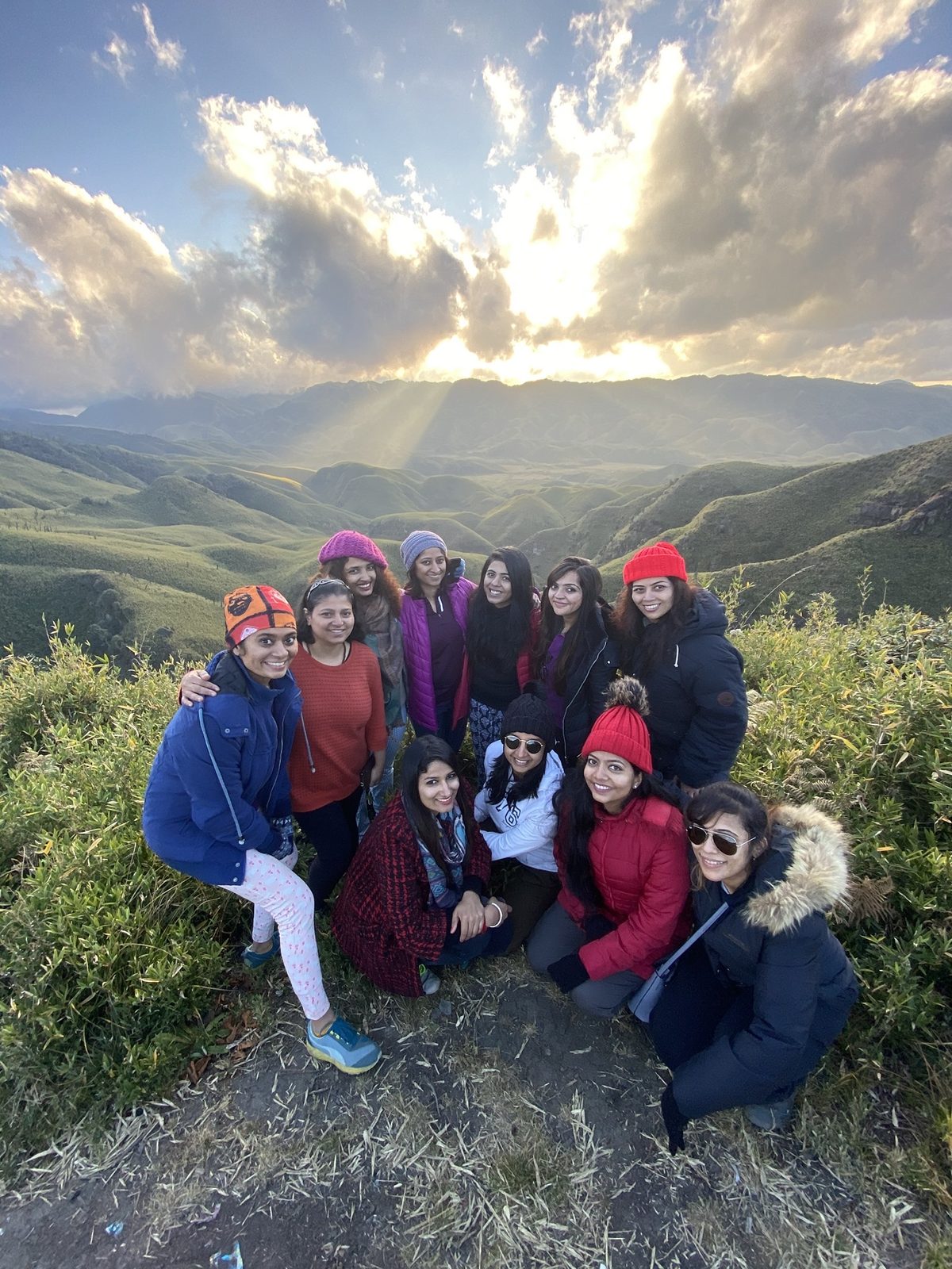 OJ group posing on the Dzouku ridge at sunset