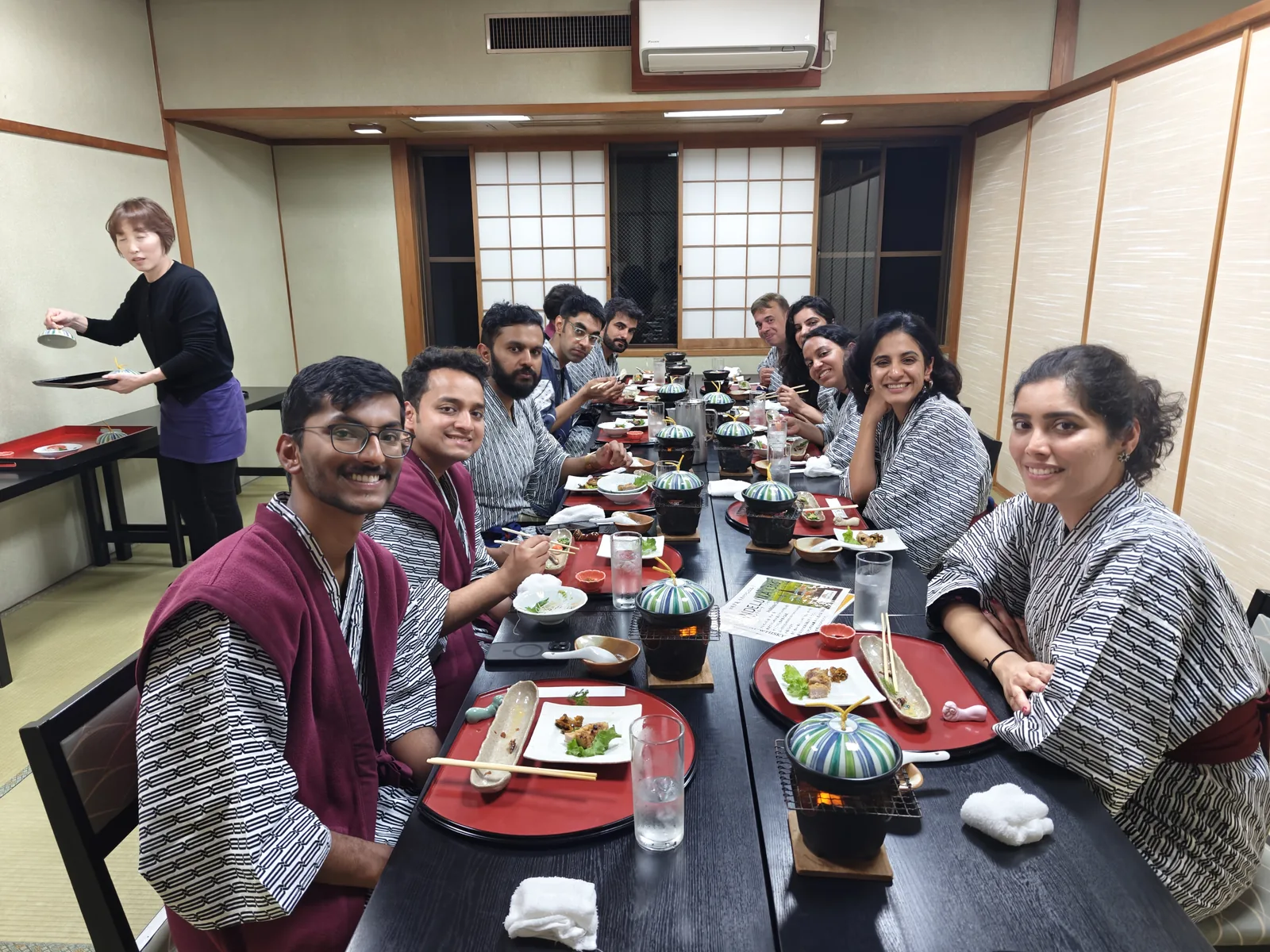 Japan, Day 10: OJ group in yukata at a long communal dinner table at the minshuku