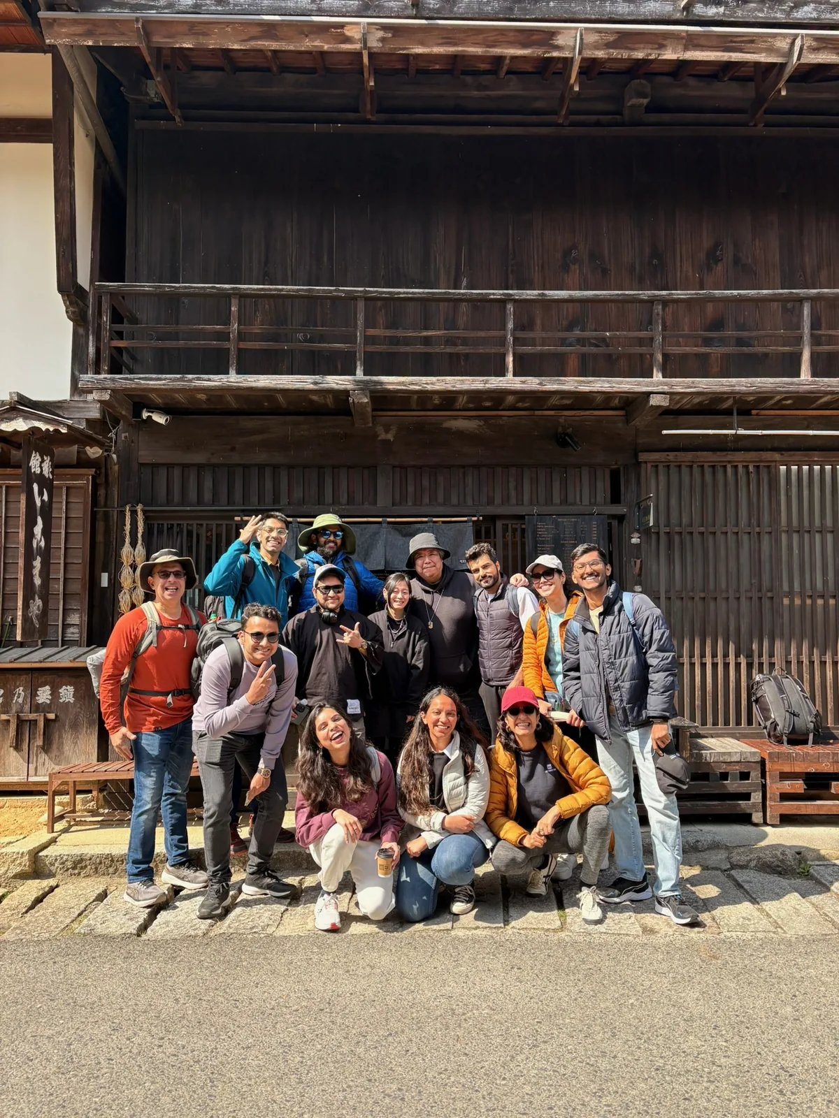 Japan Cherry Blossom, Day 10: The OJ group posing in front of a traditional wooden house in Tsumago