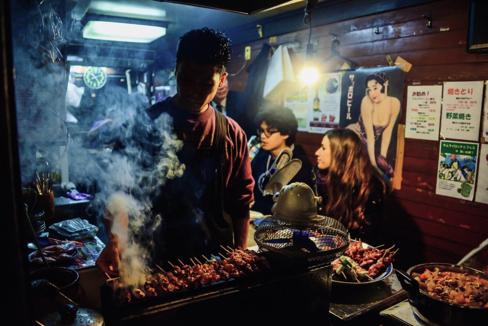 OJ trippers at a smoky yakitori stall in Tokyo