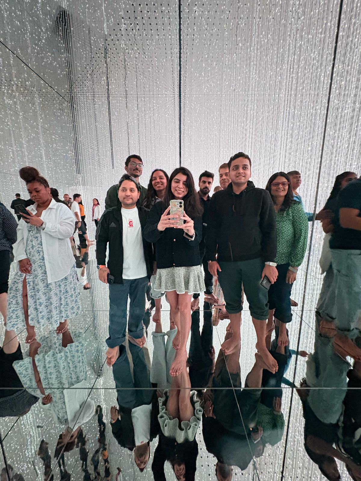 OJ group selfie in a mirrored crystal light room at teamLab