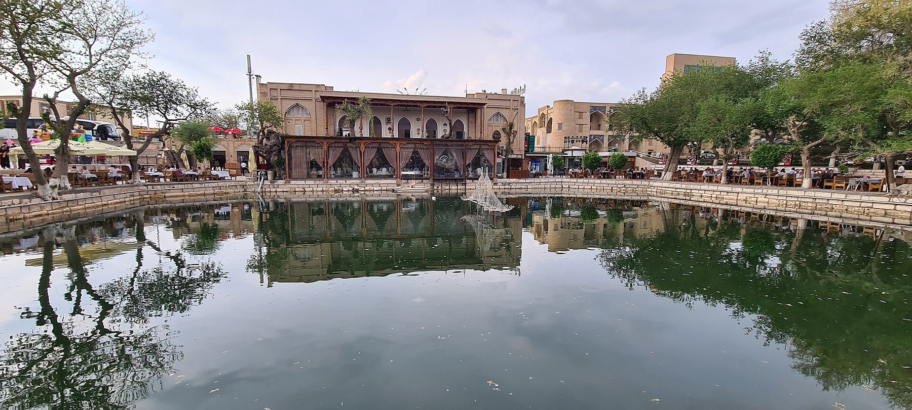 Lyab-i-Hauz pool in Bukhara with the madrasa behind