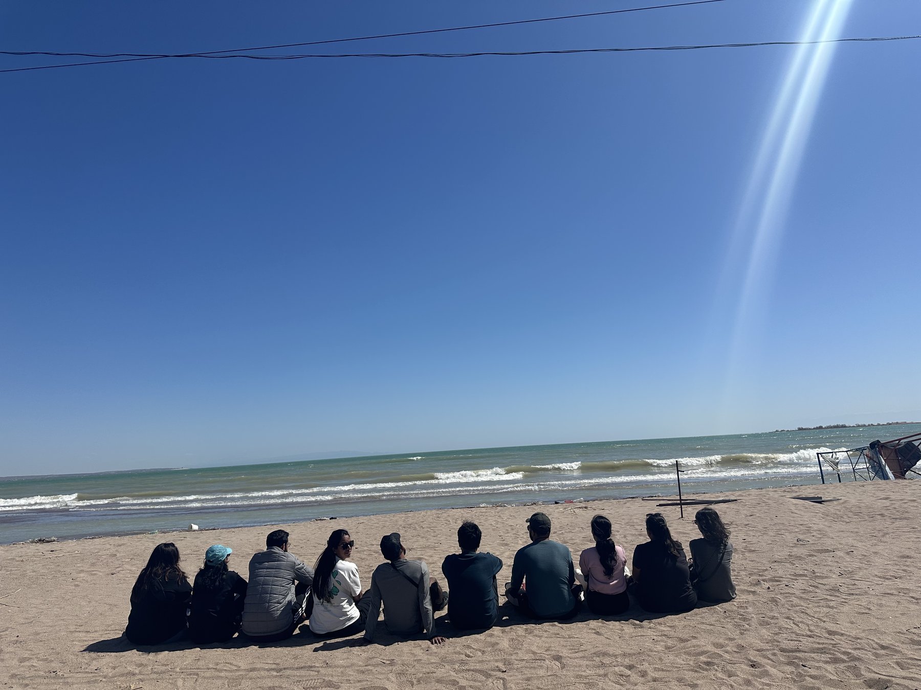 The crew sitting in a row on the Kapchagay shore