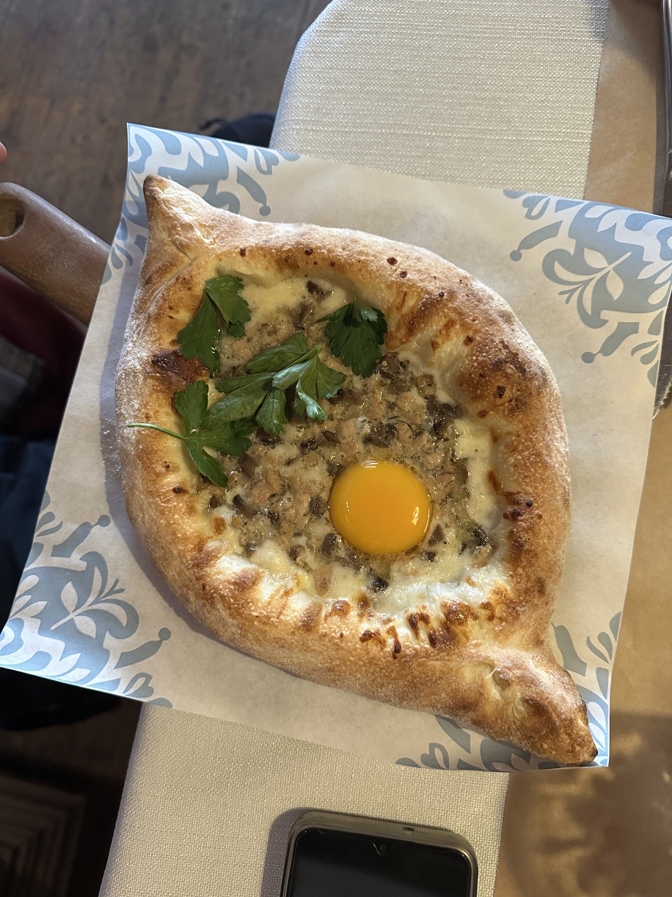 Adjarian khachapuri with an egg yolk, the Georgian dinner