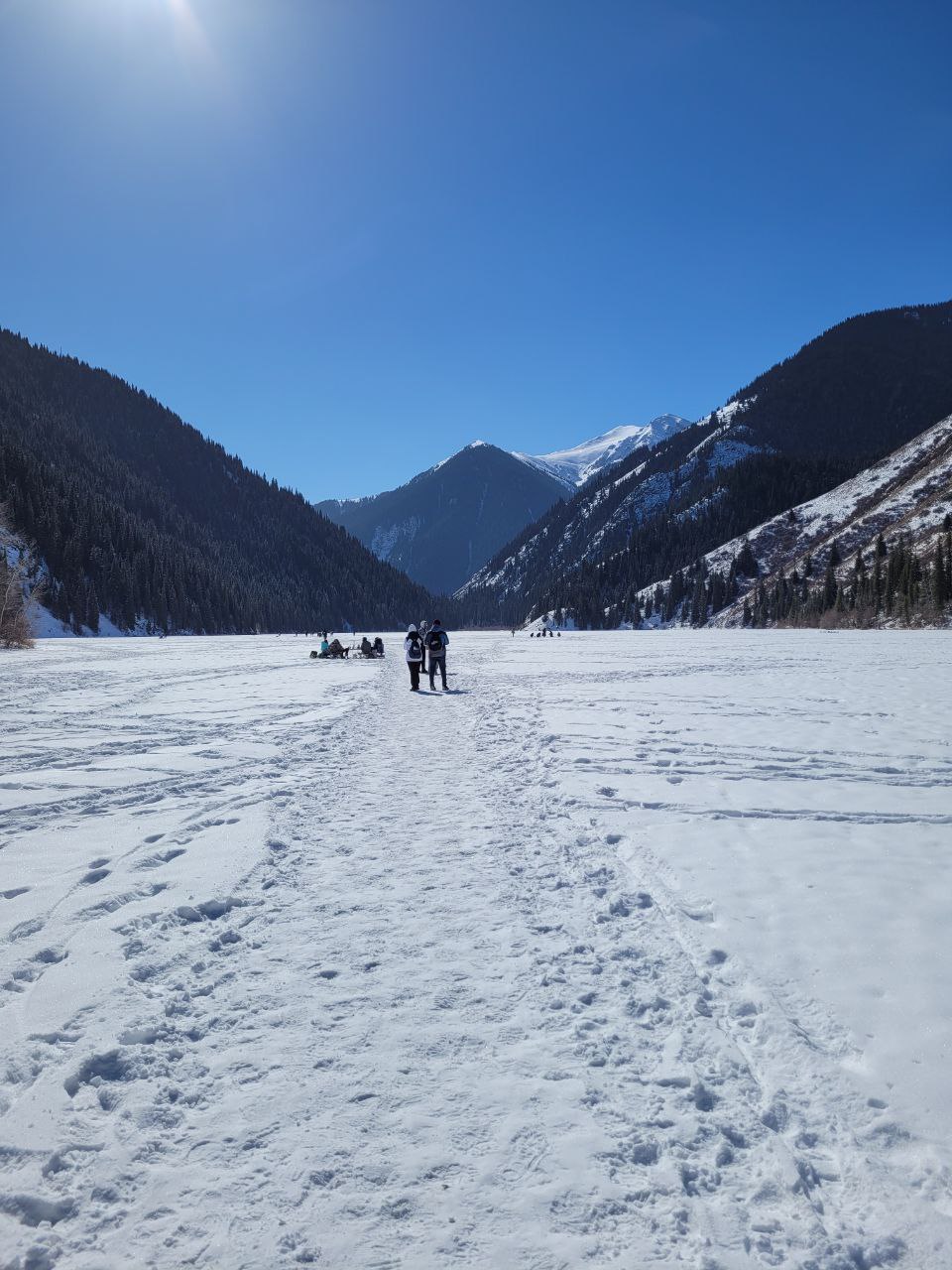 Walking on the frozen surface of Kolsai Lake