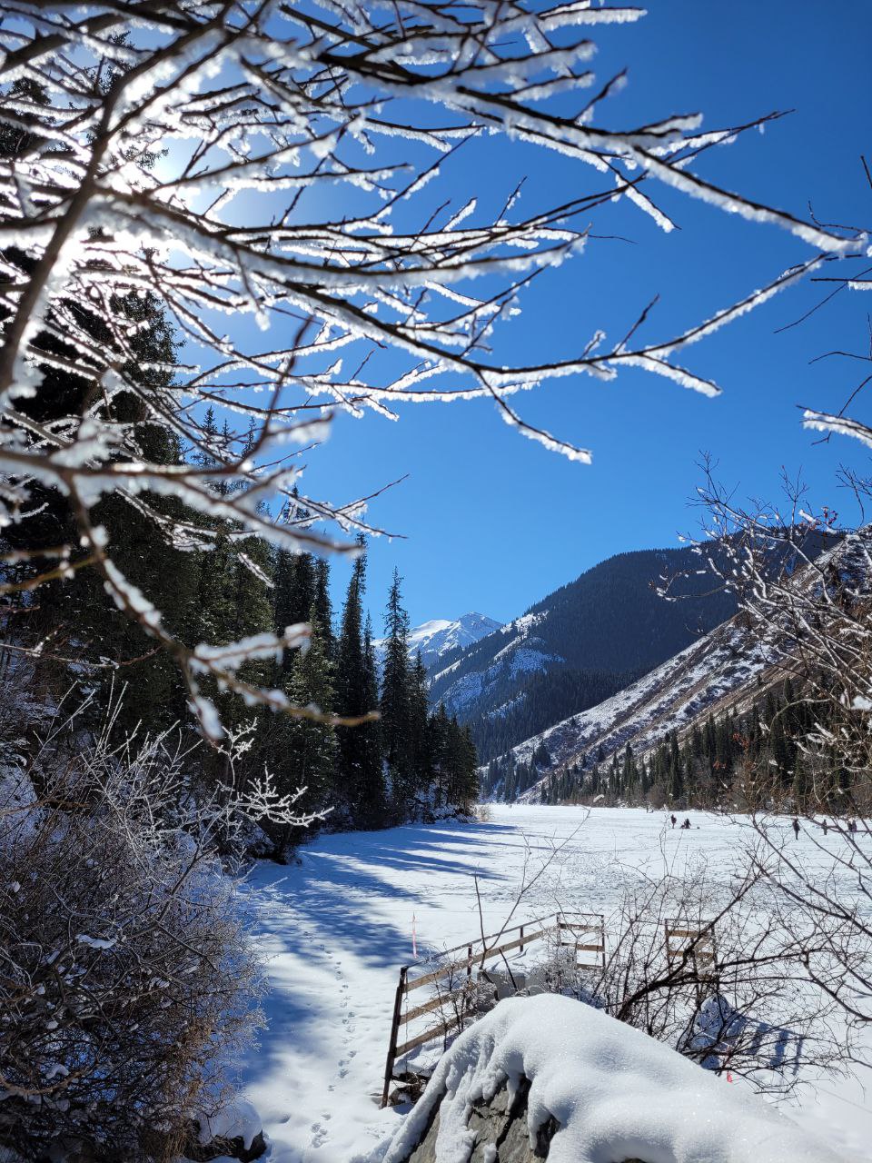 Kolsai Lake in winter, surrounded by Tian Shan peaks