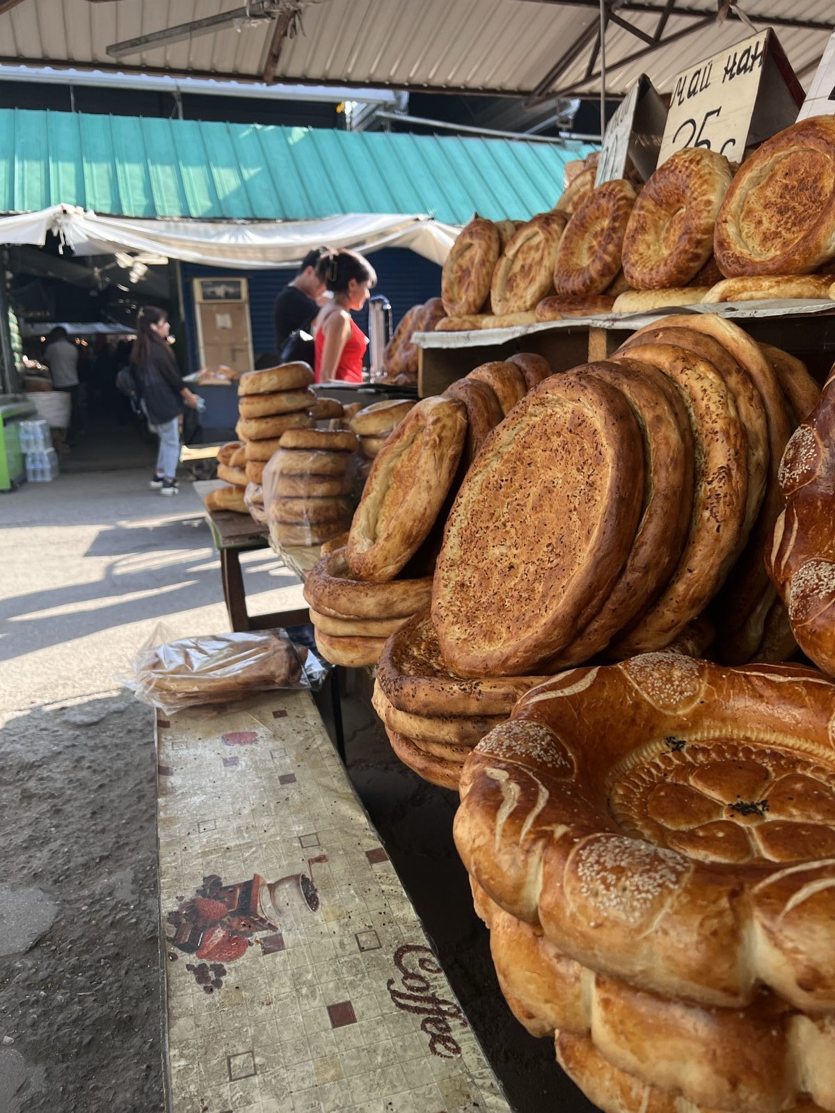 Stacks of stamped flatbread at a market stall