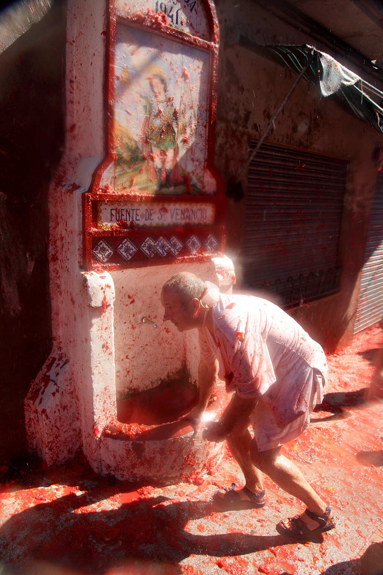 Crowds covered in red tomato pulp at La Tomatina in Bunol, Spain