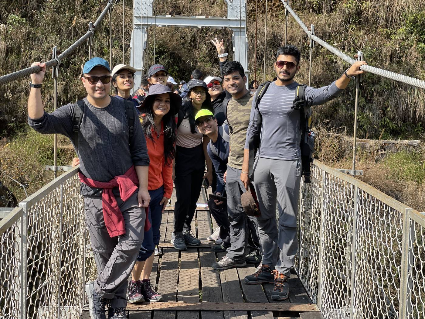 Meghalaya, Day 3, sacred forest and David Scott Trail: group smiling on a suspension bridge on the trail