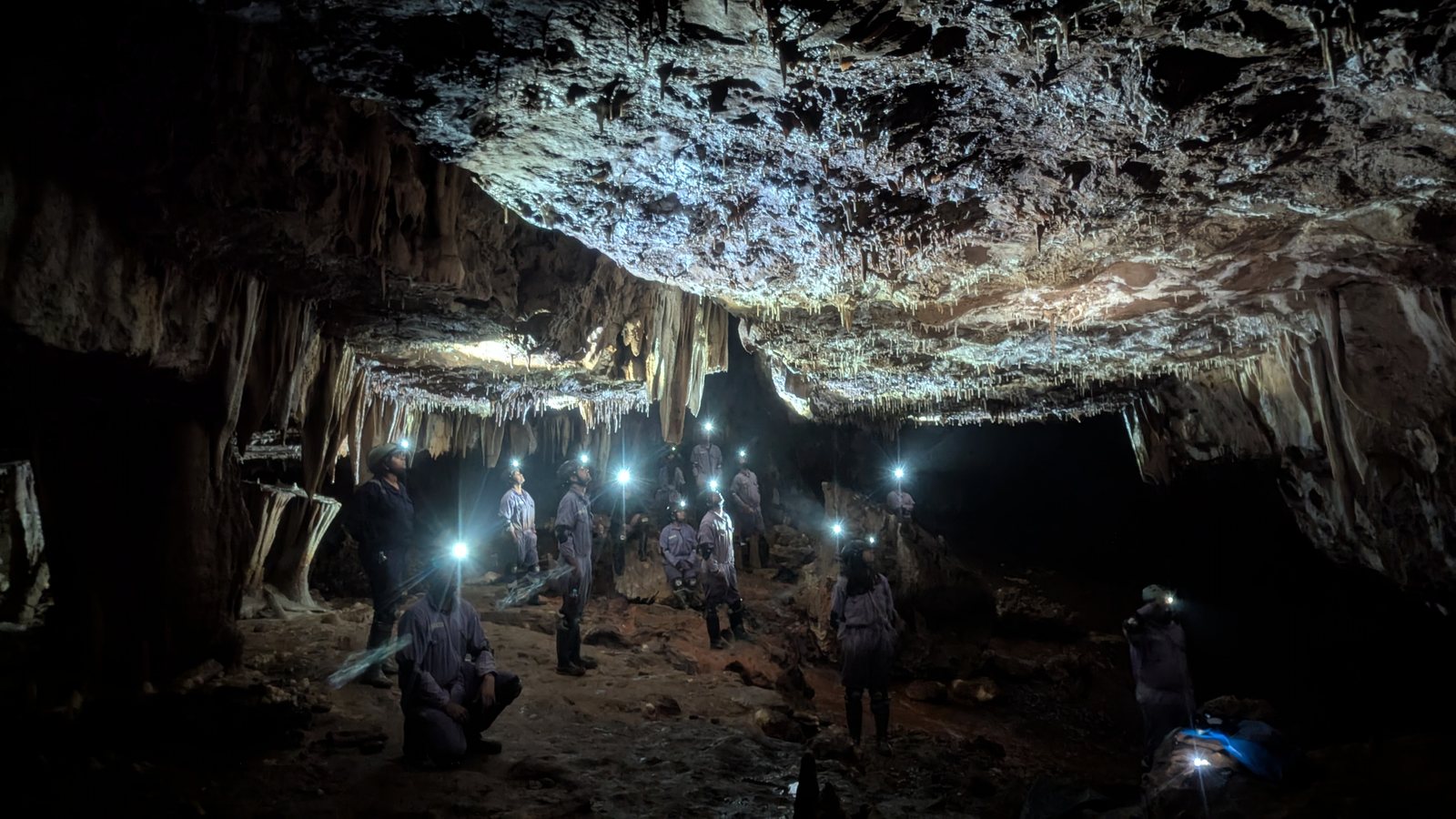 Meghalaya, Day 6, caving: group with headlamps in a vast limestone cave chamber