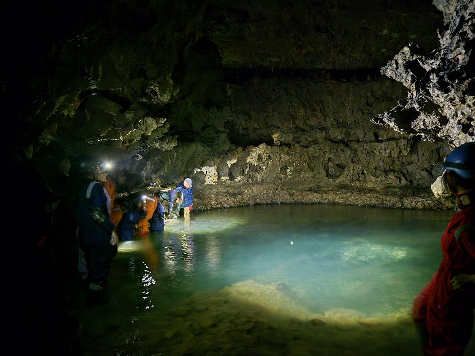 Meghalaya, Day 6, caving: group wading a turquoise pool inside the cave