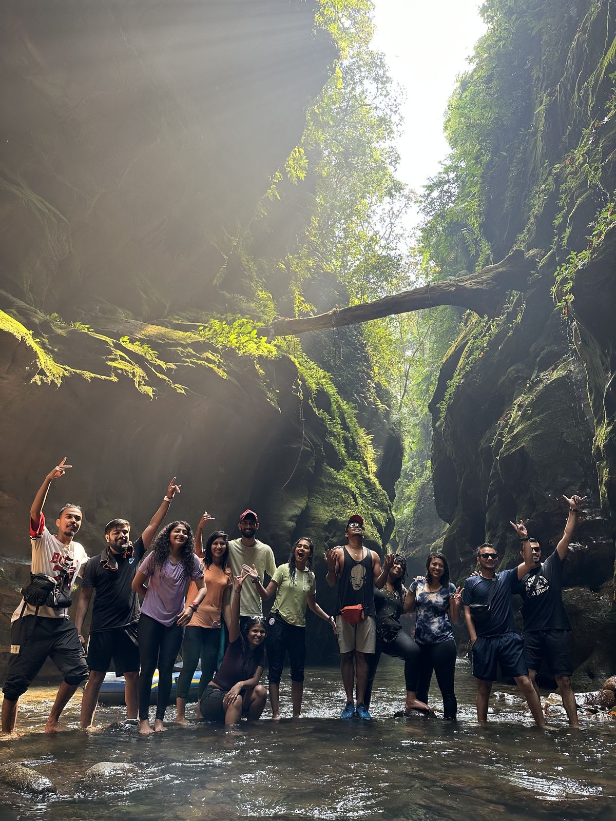 Meghalaya, Day 2, river canyoning: group cheering in a narrow green gorge with light shafts