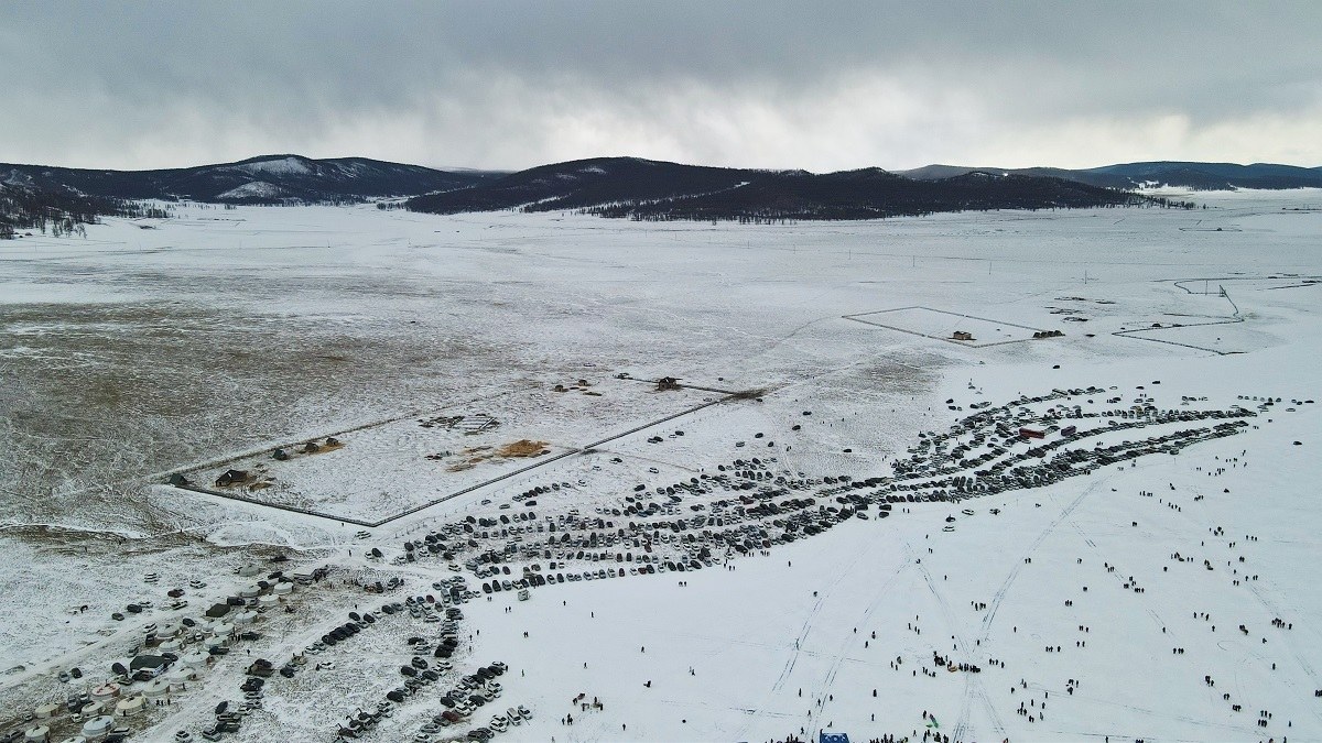 Wide view of the festival field on frozen Lake Khuvsgul with mountains behind