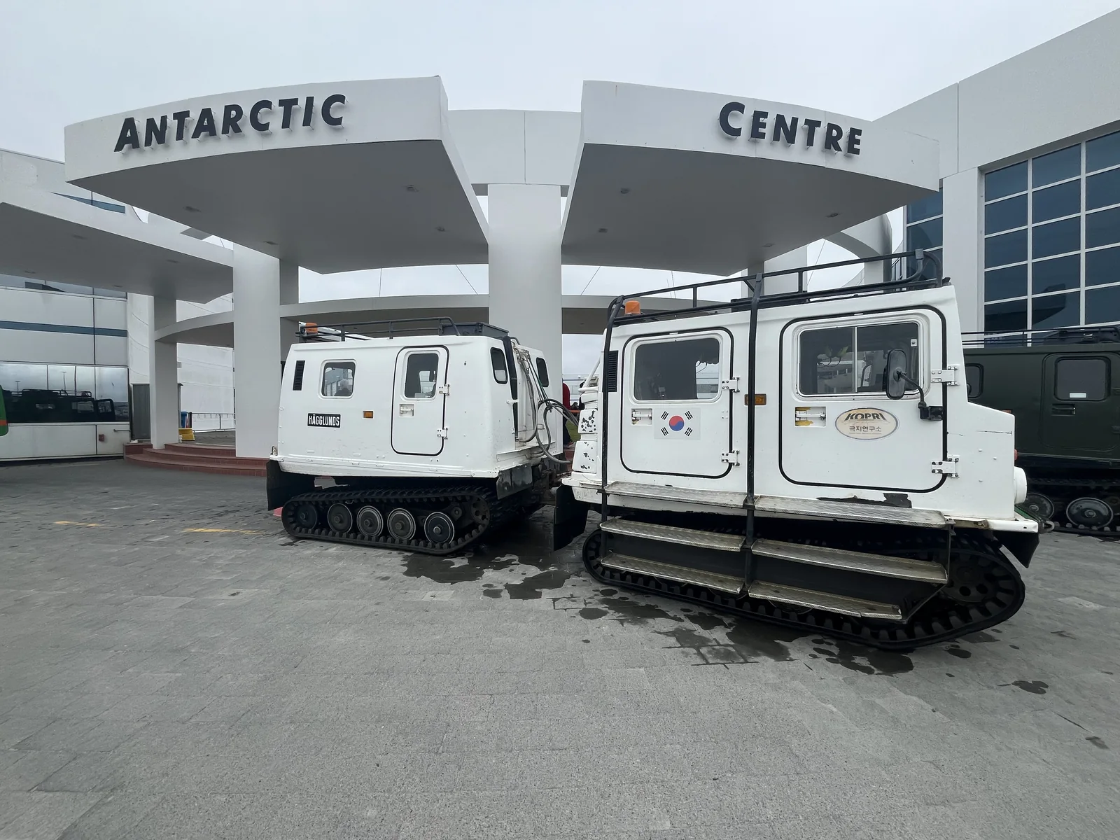 White snow vehicles parked outside the International Antarctic Centre in Christchurch