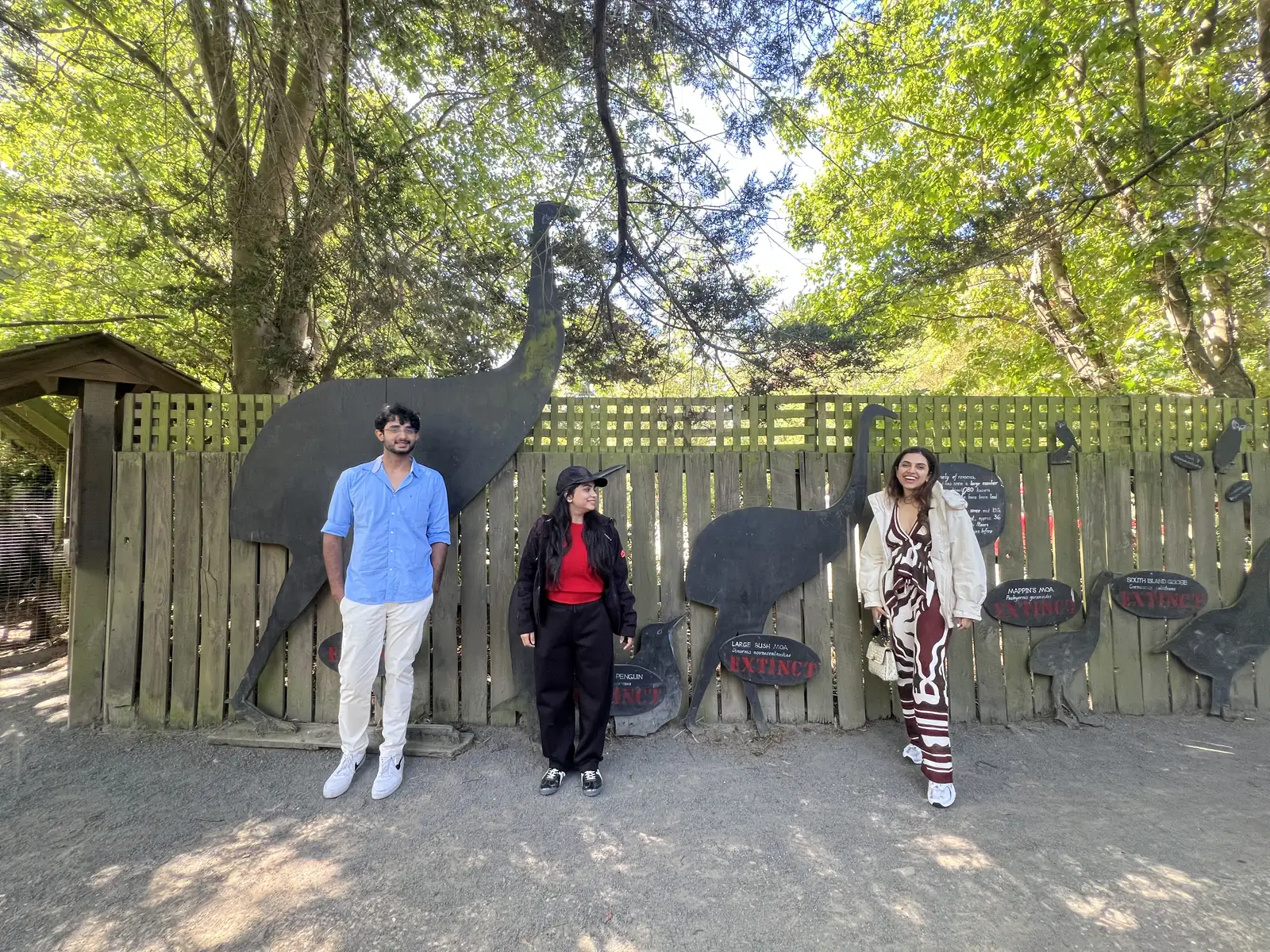 Three OJ trippers posing in front of giant bird silhouettes at Willowbank Wildlife Reserve
