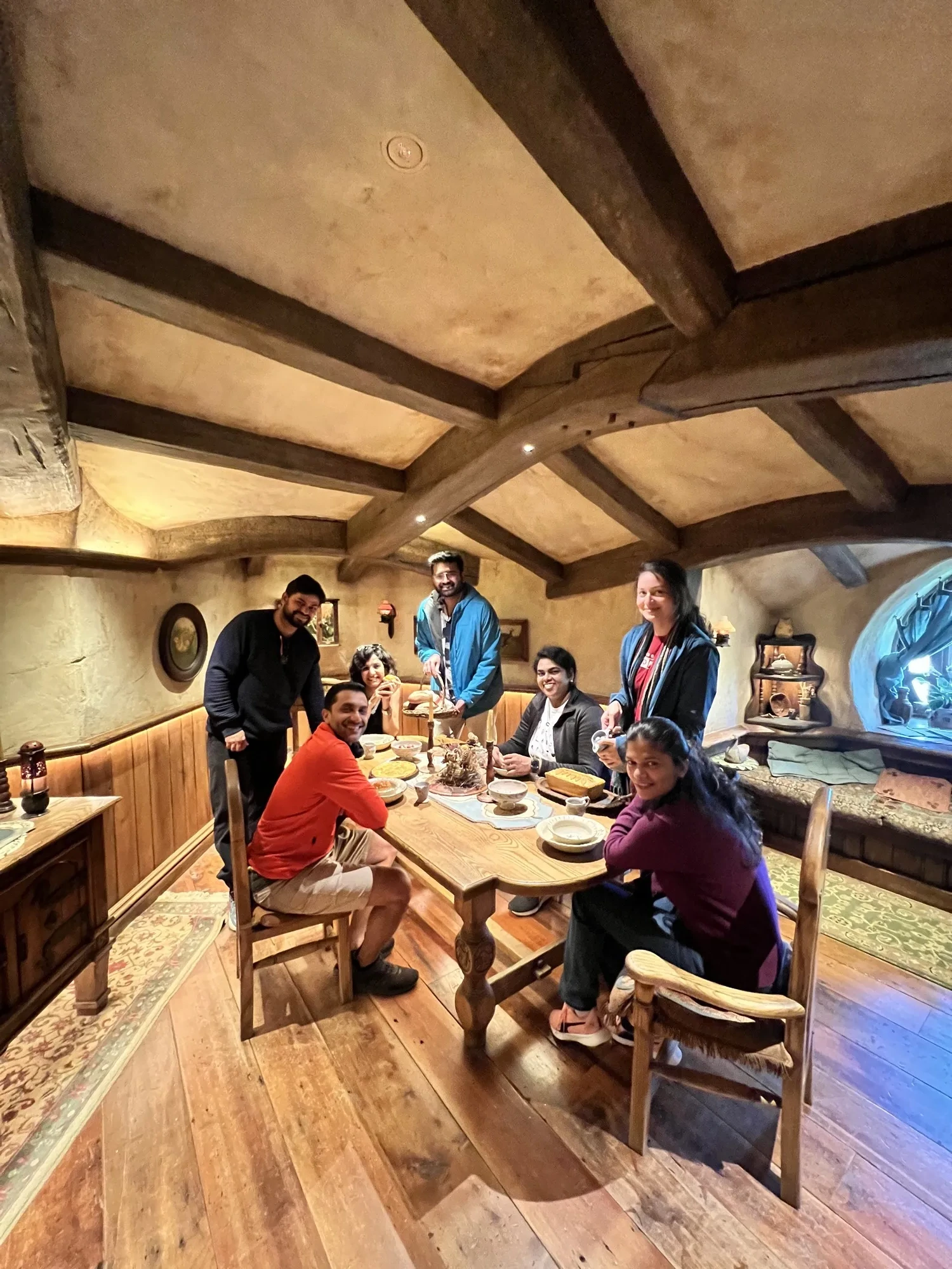 New zealand day 3 group travelers gathered around table