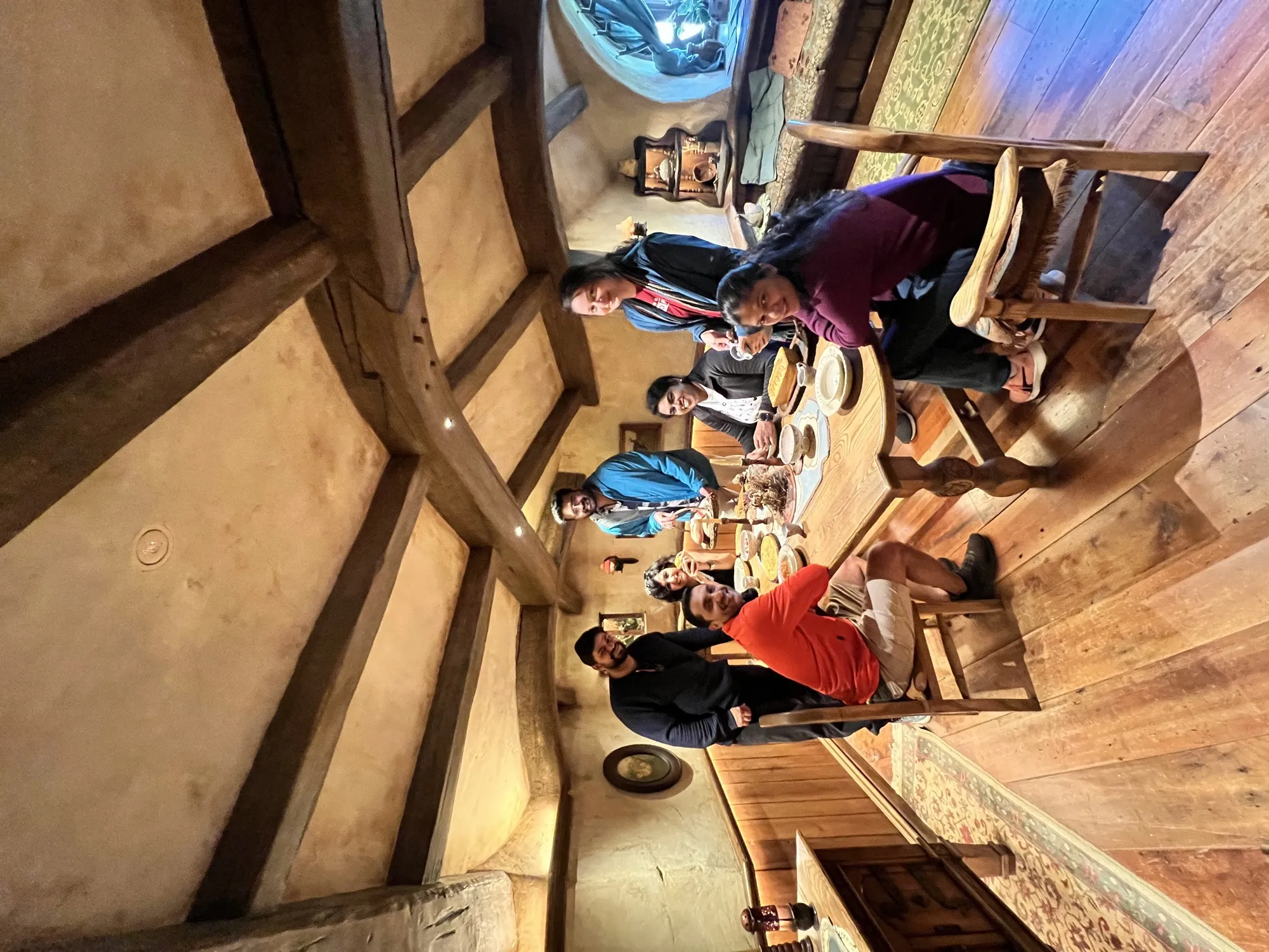 New zealand day 3 group travelers gathered around table