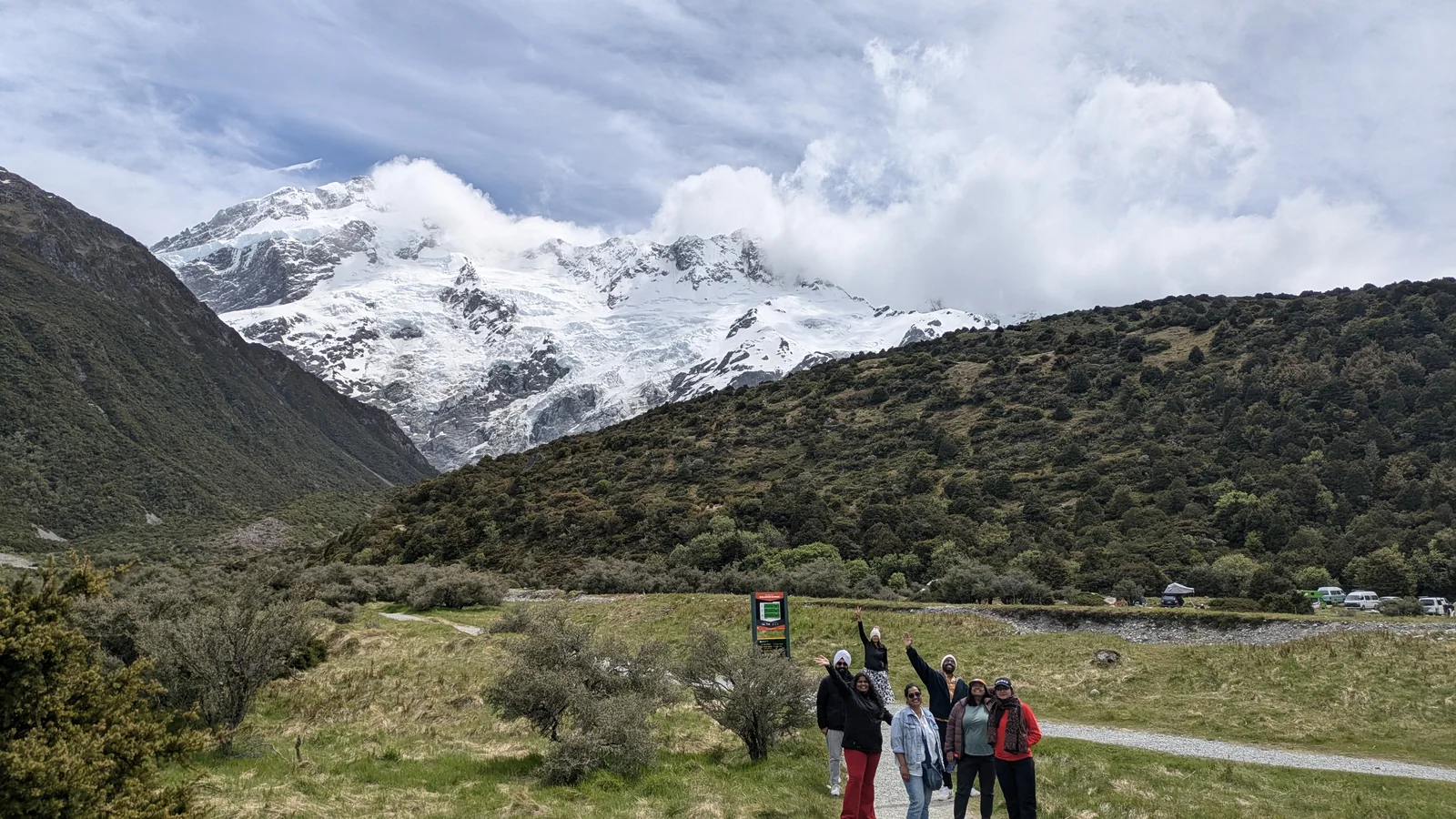 OJ group standing on the Hooker Valley track with snow-capped Mount Cook peaks behind