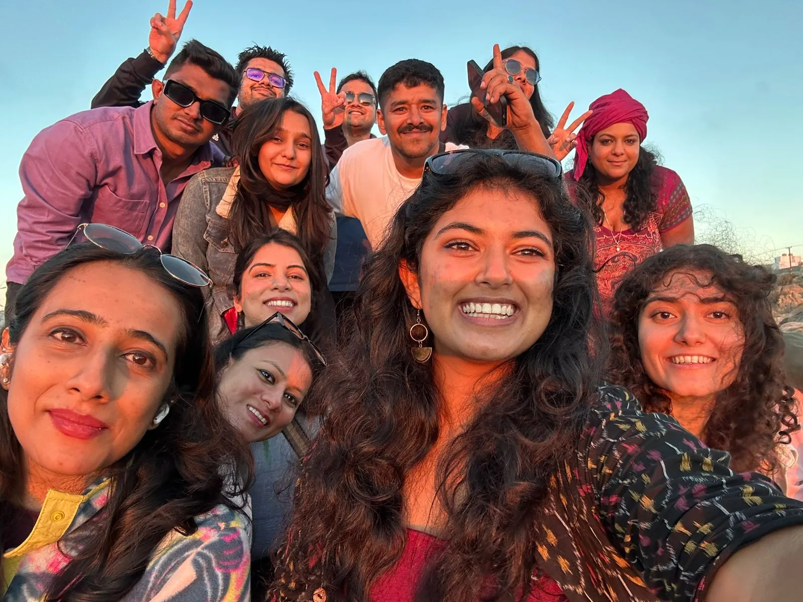 OJ crew selfie in golden light, everyone laughing