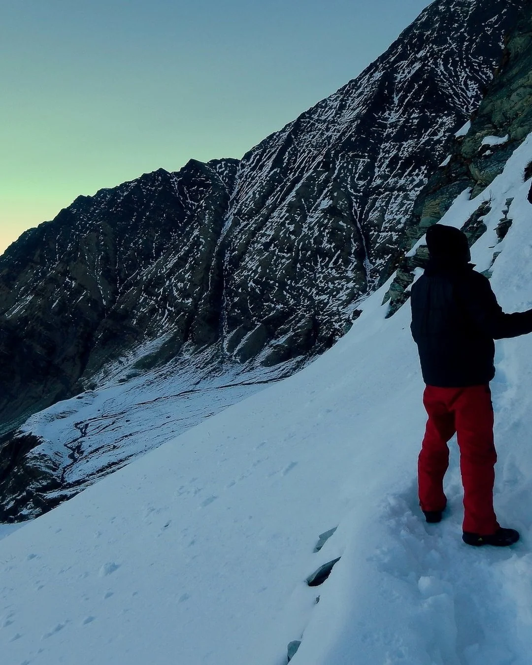 Trekker on the snowy ridge above Roopkund