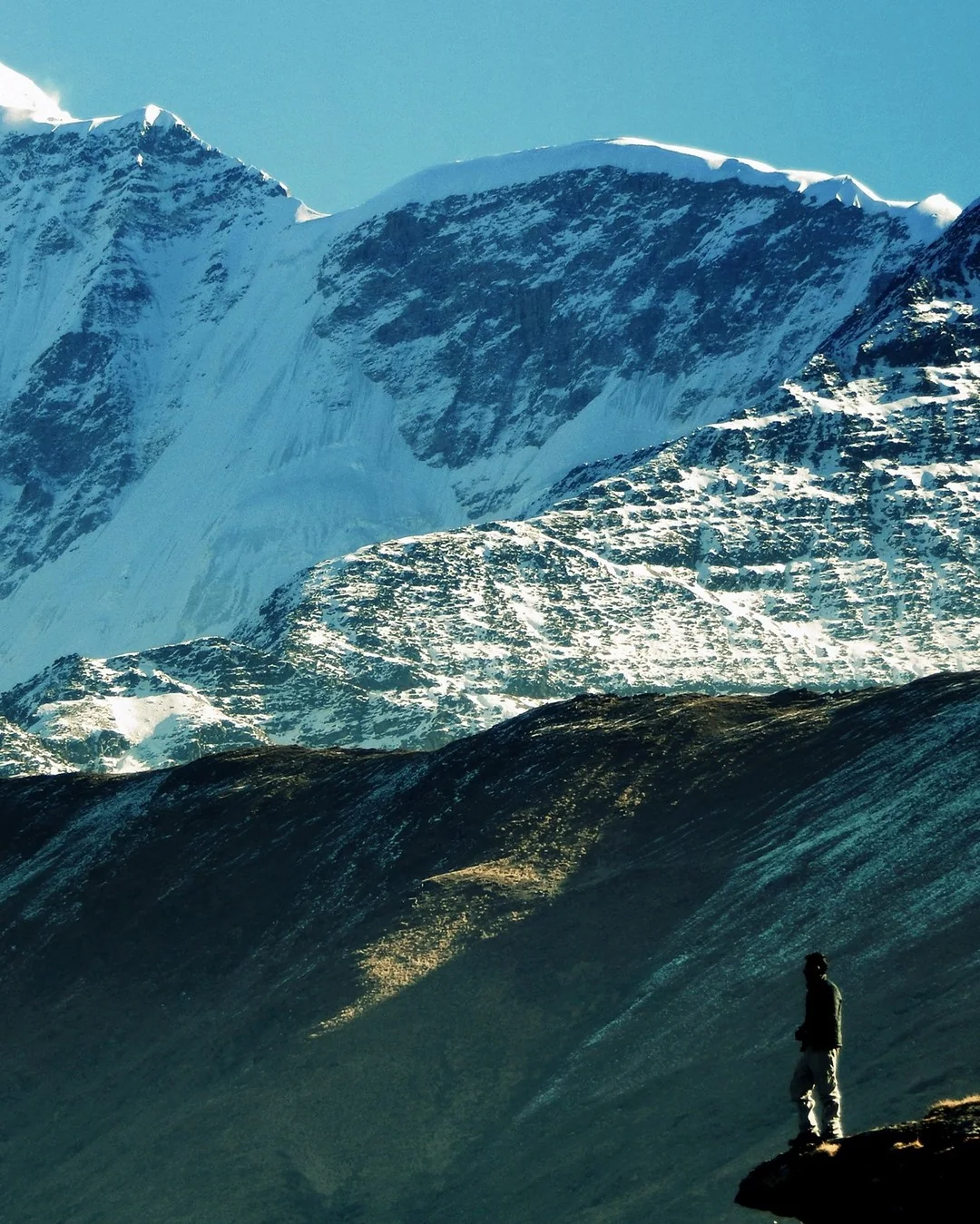 Trekker below the Trishul ice wall